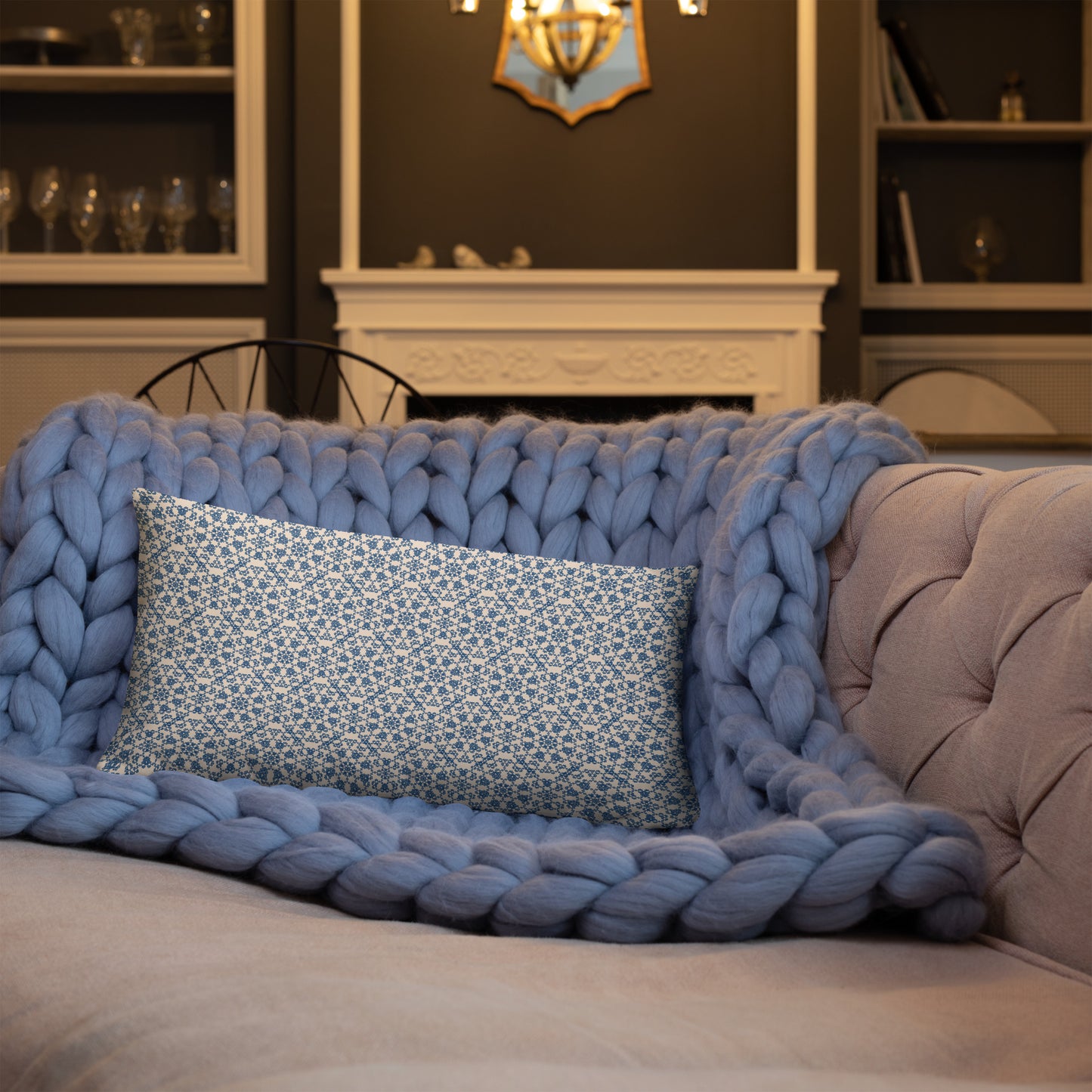 20″×12″ throw pillow with the ‘Octagon’ navy and beige geometric pattern on a sofa with chunky knit blanket.
