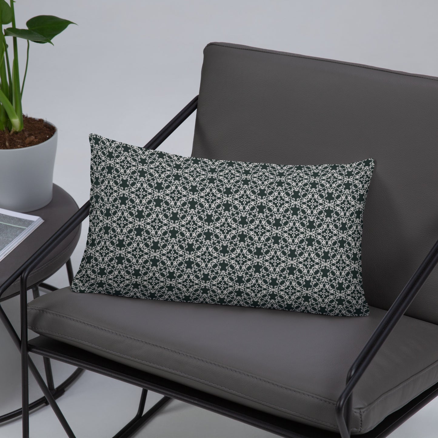 20″×12″ throw pillow with the 'Tetragon' charcoal and white geometric pattern on a chair.