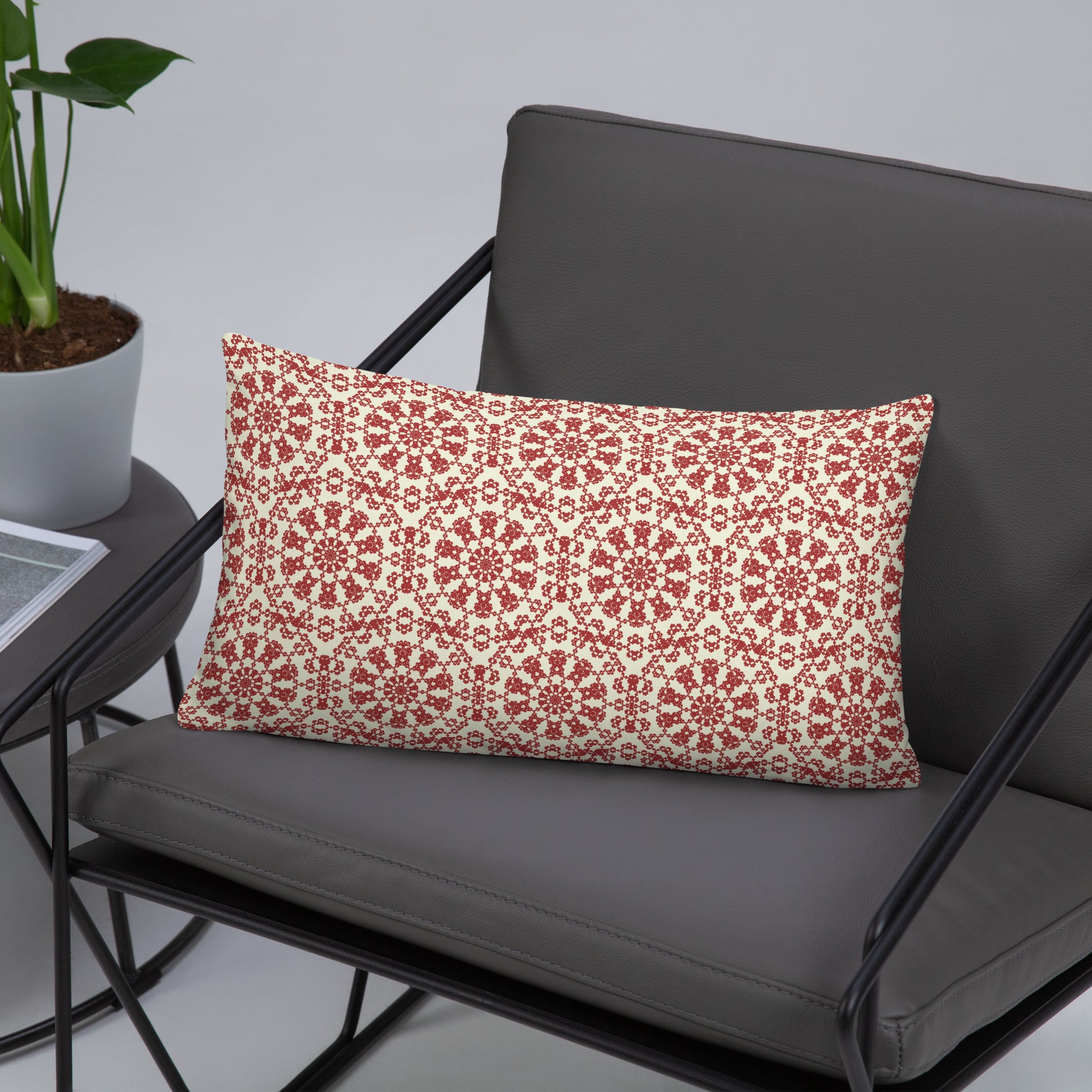 20″×12″ throw pillow with the ‘Decagon’ terracotta and beige geometric pattern on a charcoal metal chair.