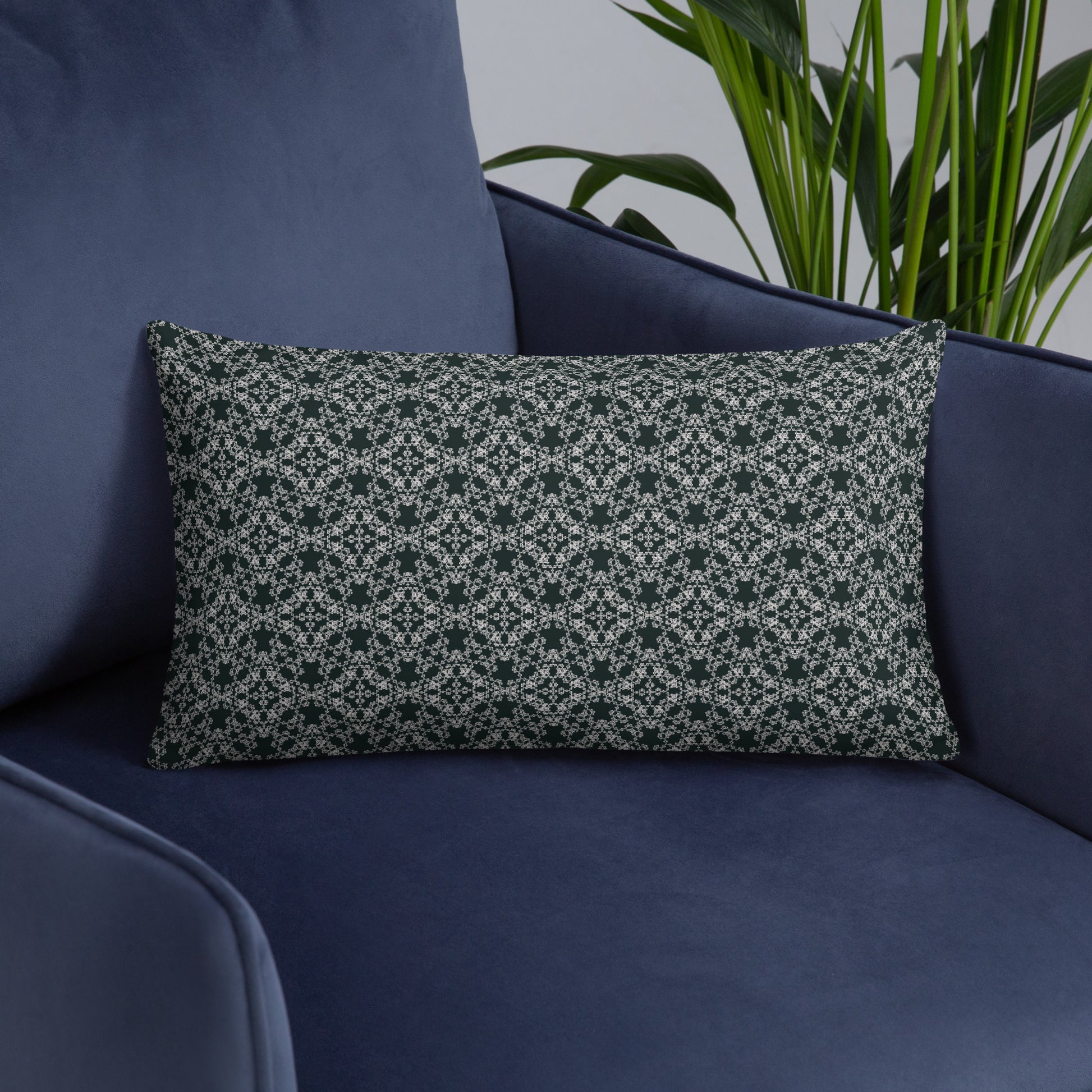 Front of the 20″×12″ basic pillow with the 'Quadragon' charcoal and white fractal geometric pattern on an armchair.