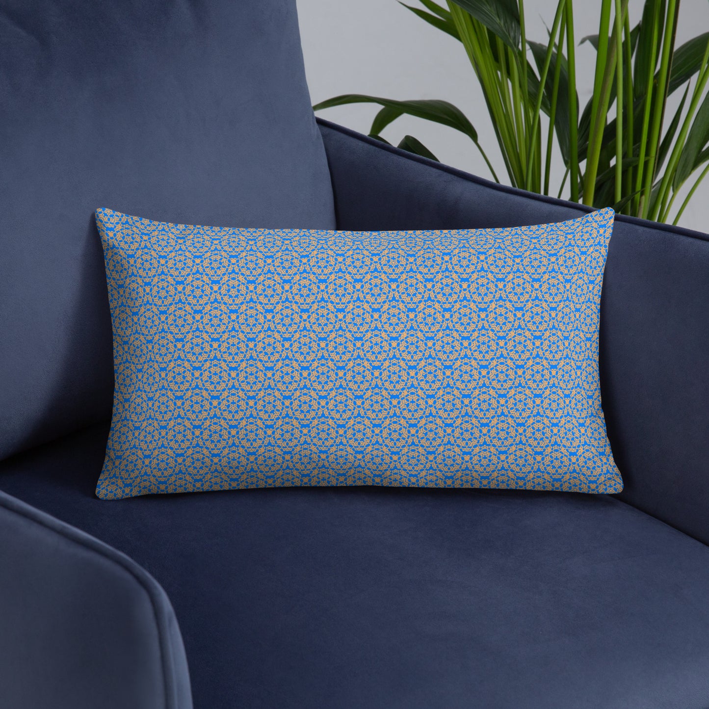 Front of the 20″×12″ basic pillow with the 'Pentagon' blue and yellow fractal geometric pattern on an armchair.