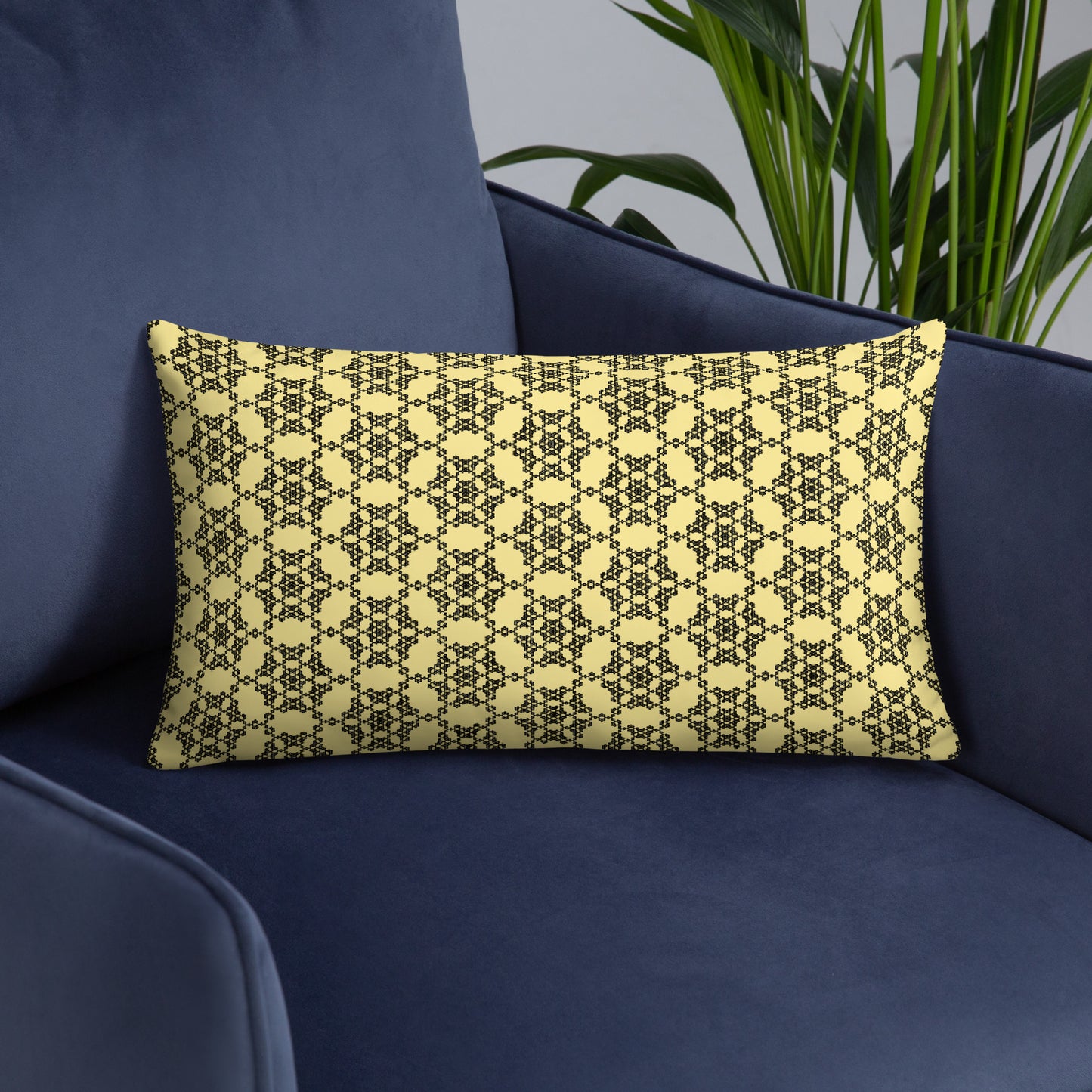 20″×12″ throw pillow with the 'Hexagon' yellow and black geometric pattern on an armchair.