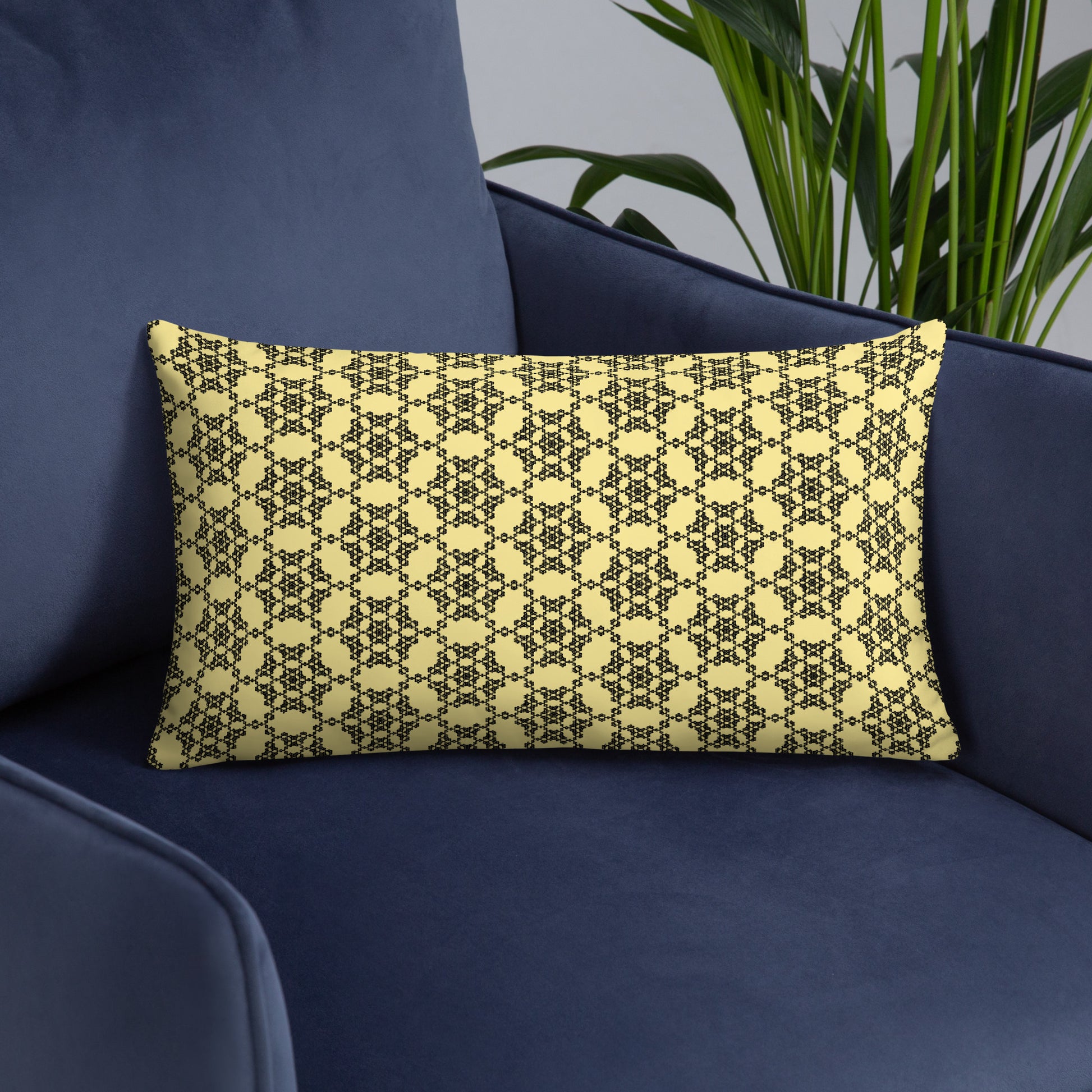 20″×12″ throw pillow with the 'Hexagon' yellow and black geometric pattern on an armchair.