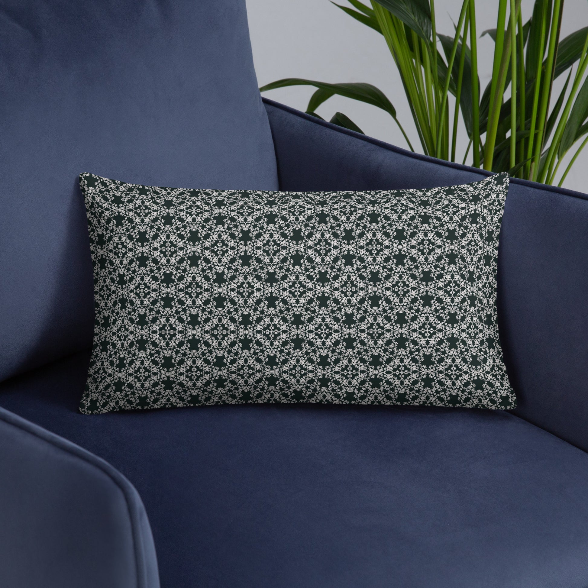 20″×12″ throw pillow with the 'Tetragon' charcoal and white geometric pattern on an armchair.