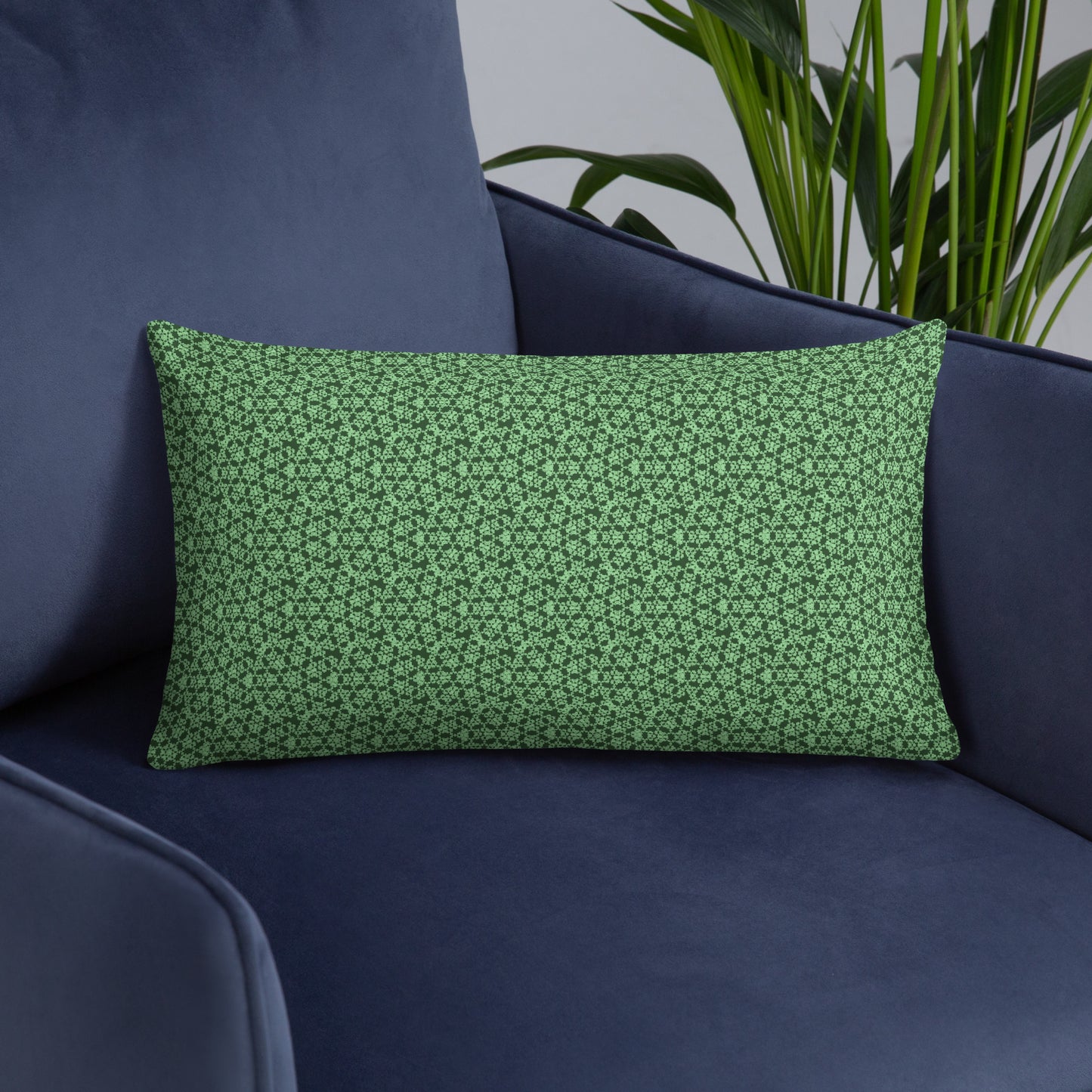 20″×12″ throw pillow with the 'Heptagon' green geometric pattern on an armchair.