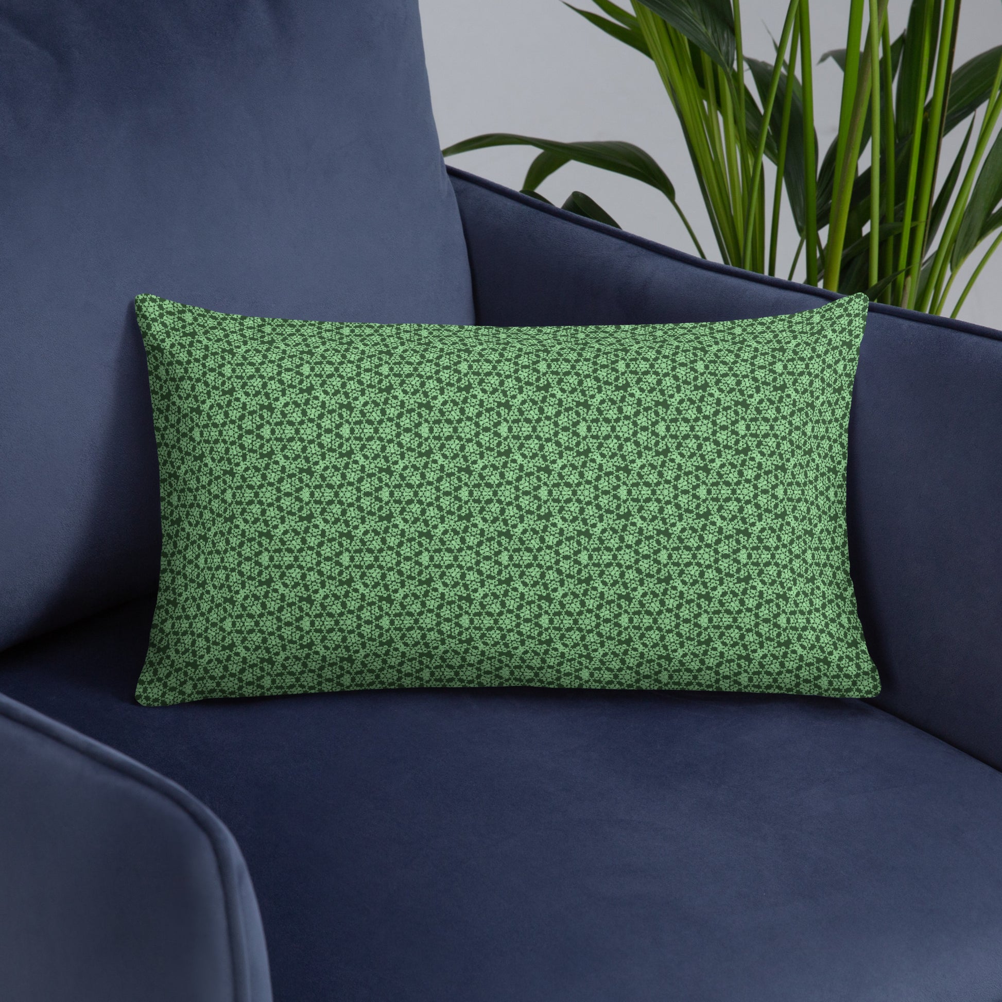 20″×12″ throw pillow with the 'Heptagon' green geometric pattern on an armchair.