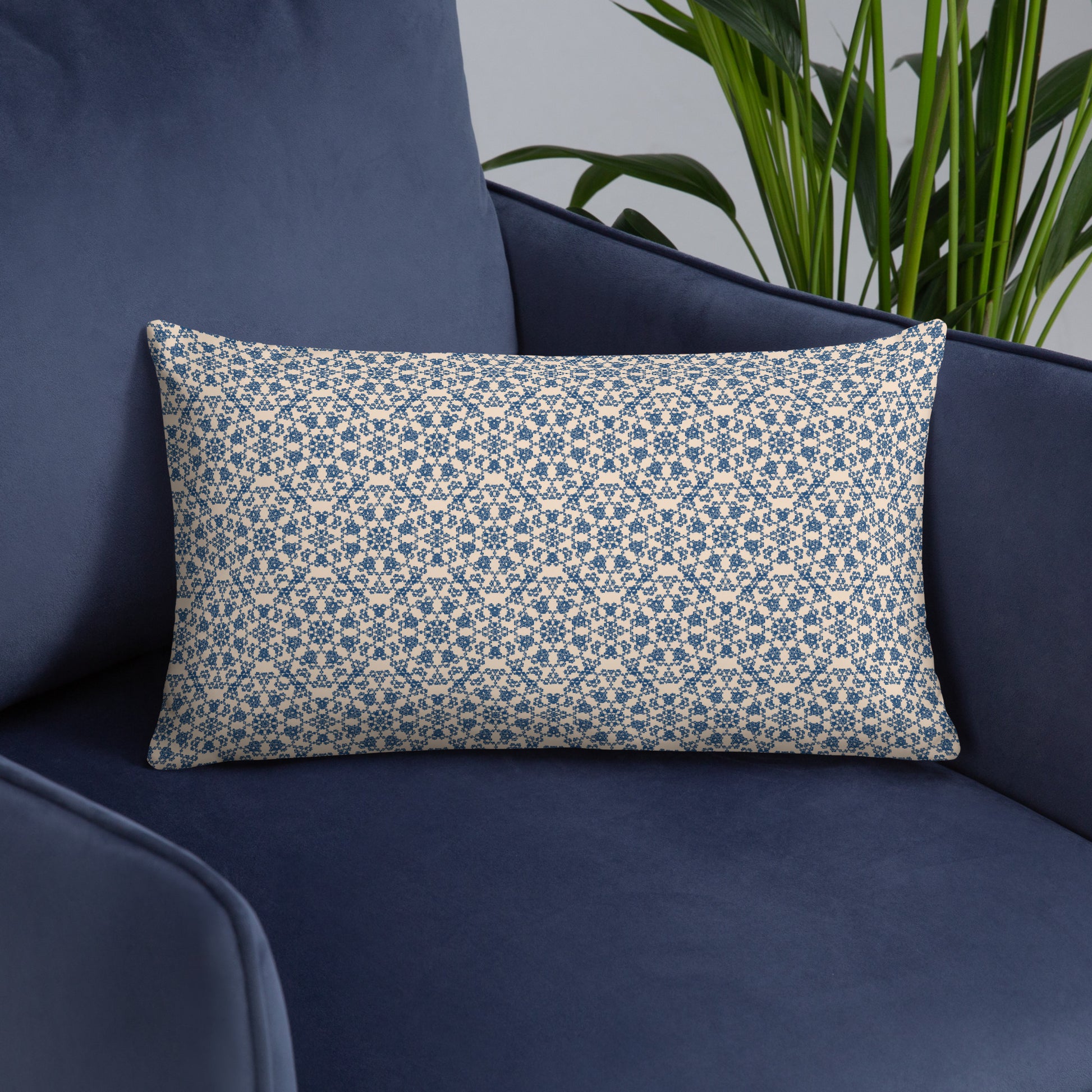 20″×12″ throw pillow with the ‘Octagon’ navy and beige geometric pattern on a navy sofa.