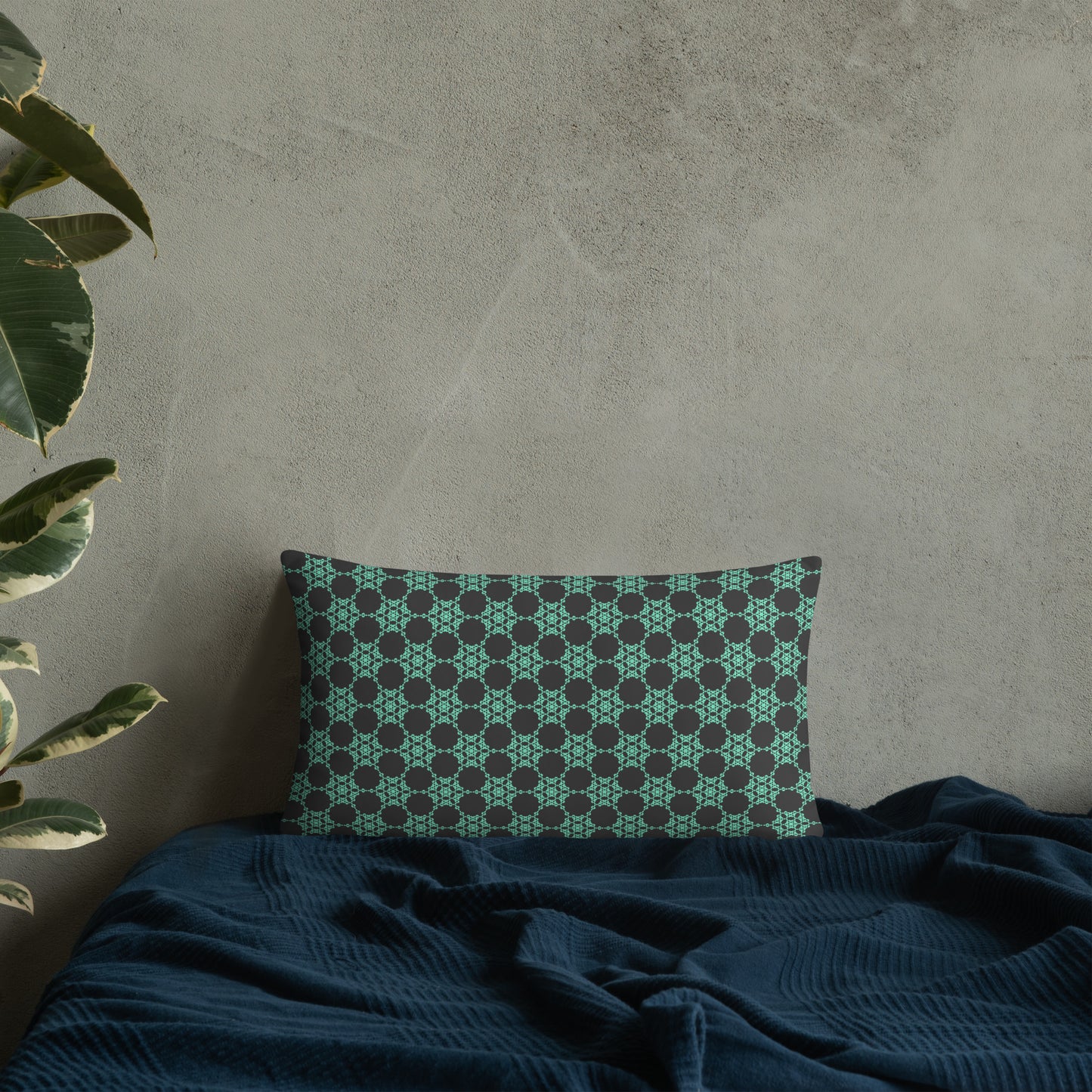 20″×12″ throw pillow with the 'Flowers Victory' charcoal and mint geometric pattern on a bed.