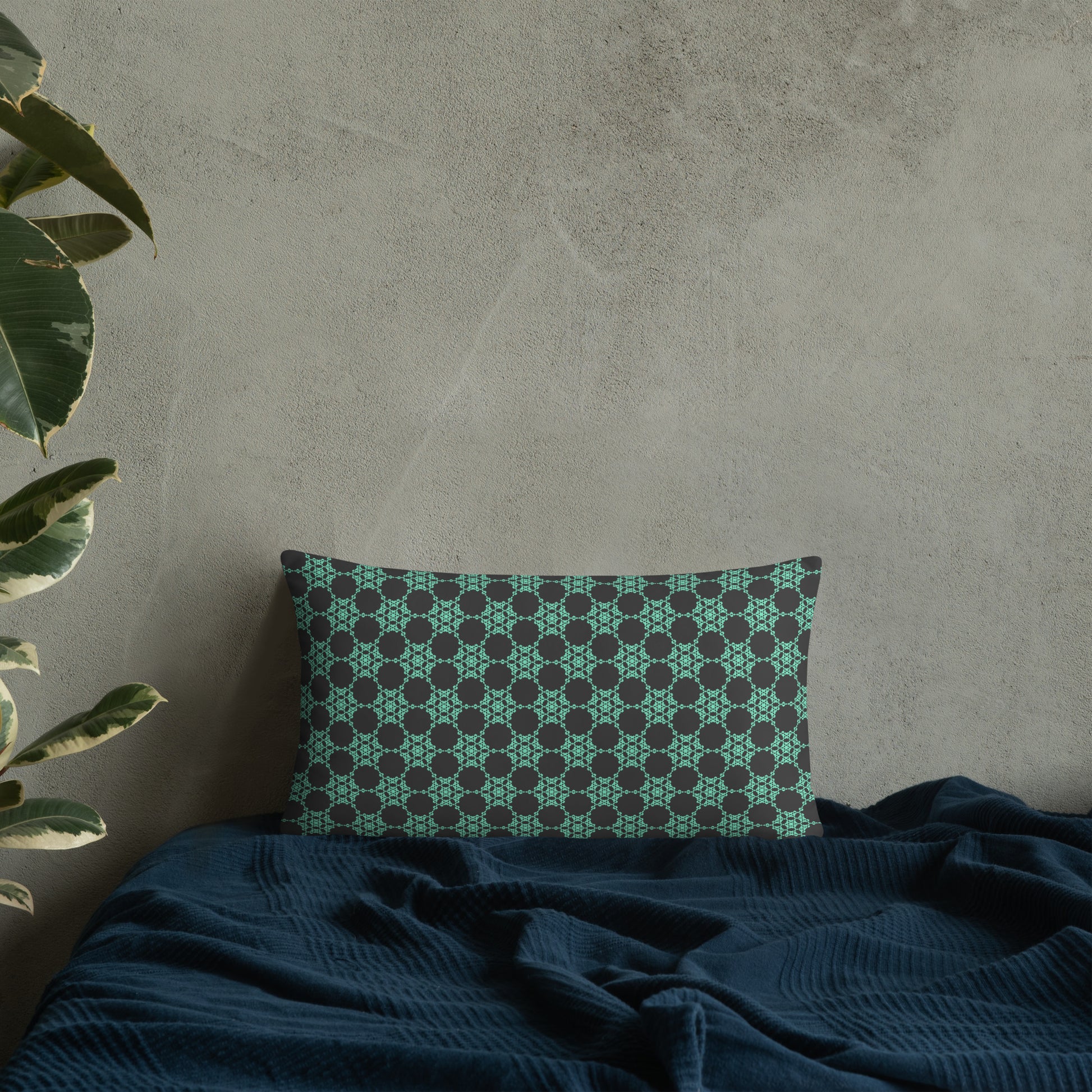 20″×12″ throw pillow with the 'Flowers Victory' charcoal and mint geometric pattern on a bed.