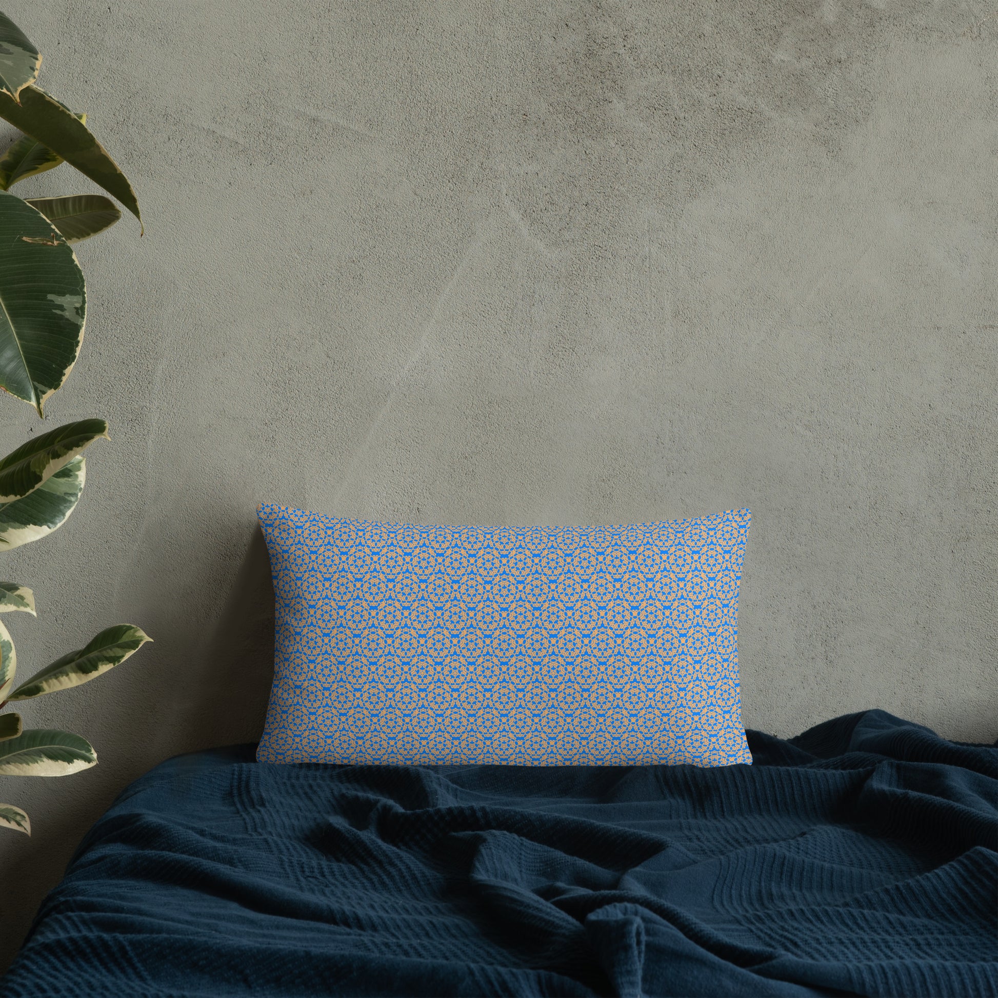 20″×12″ throw pillow with the 'Pentagon' blue and yellow geometric pattern on a bed.