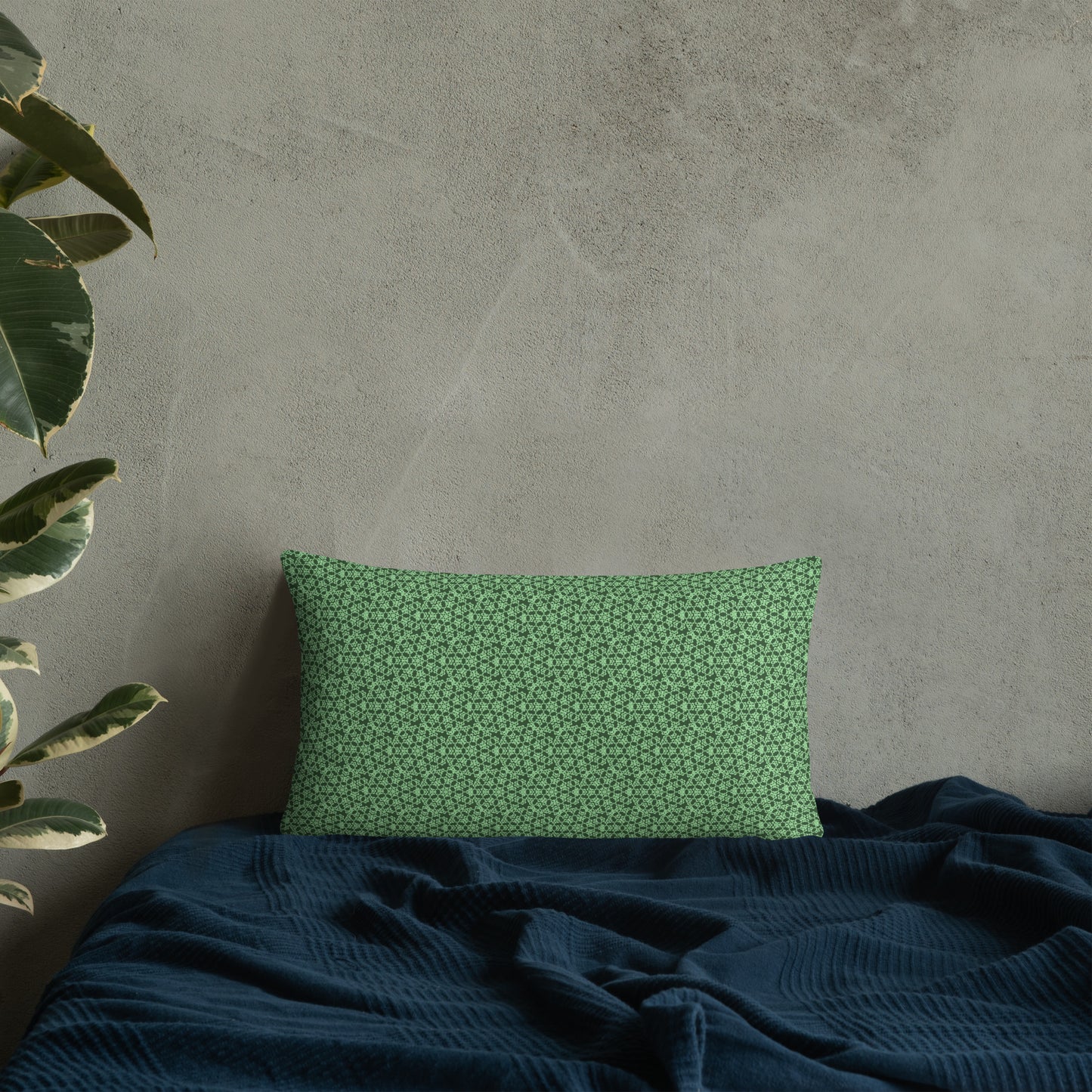 20″×12″ throw pillow with the 'Heptagon' green geometric pattern on a bed.