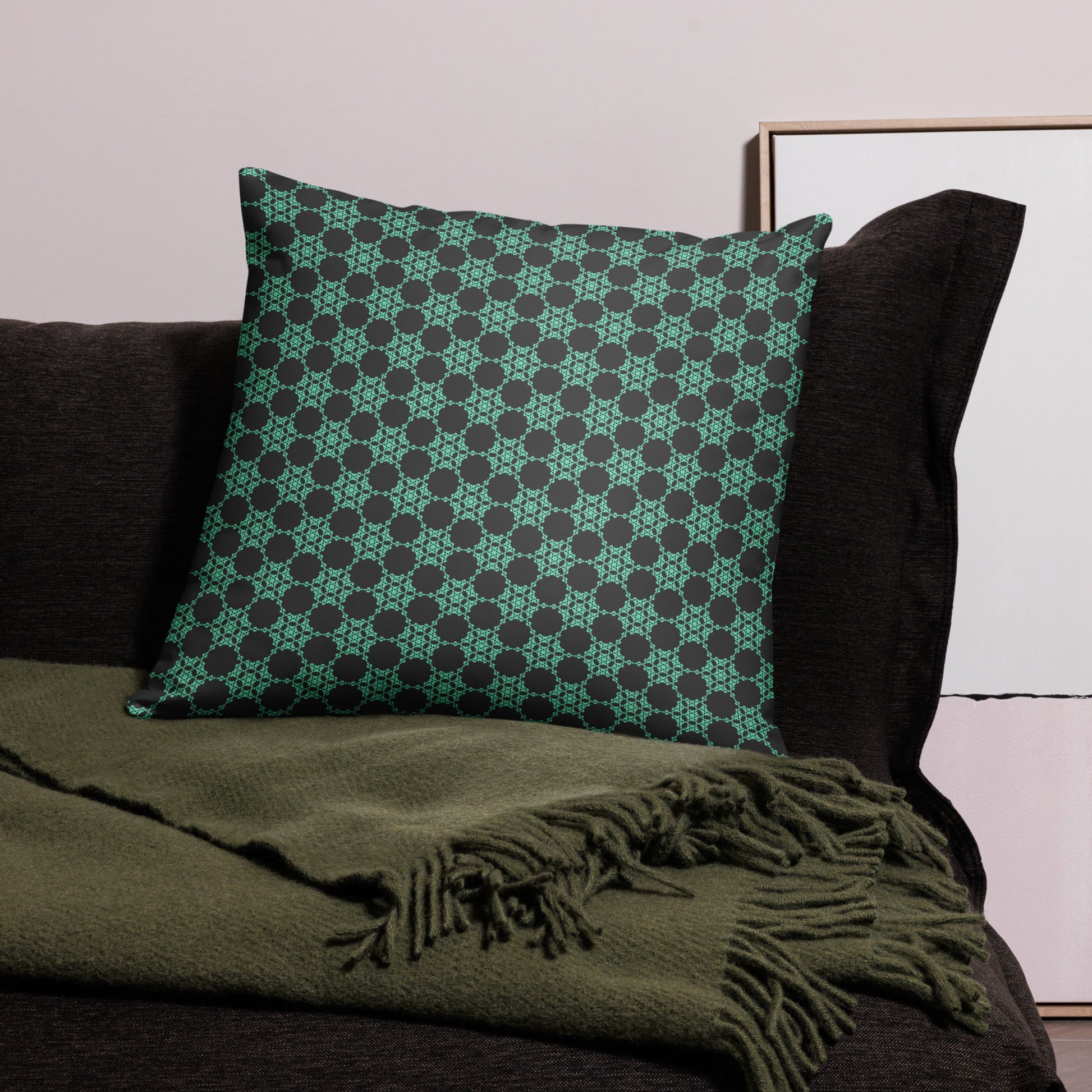 22″×22″ throw pillow with the 'Flowers Victory' charcoal and mint geometric pattern on a couch.