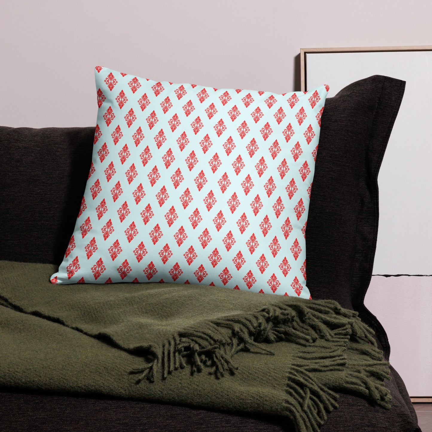 22″×22″ throw pillow with the 'Digon' sky blue and red geometric pattern on a couch.