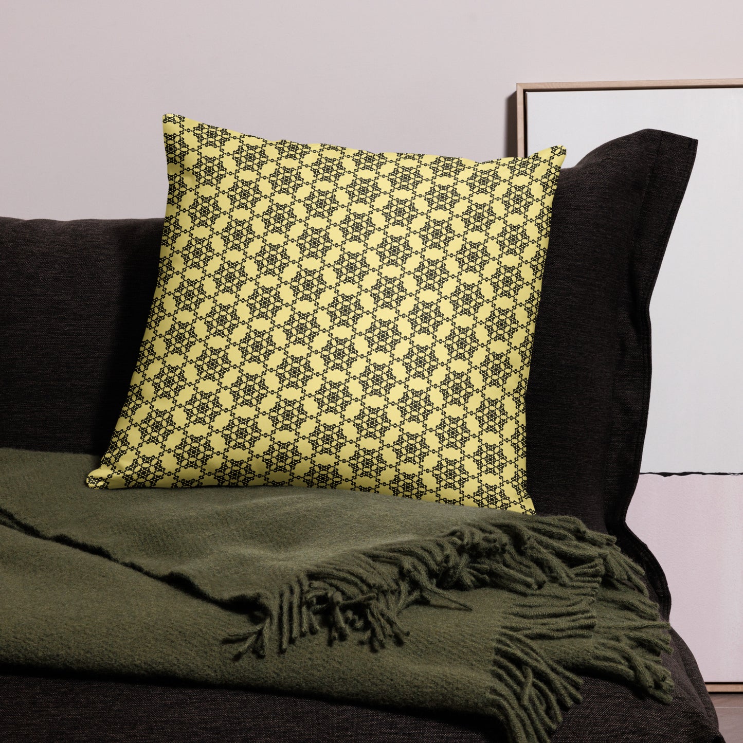 22″×22″ throw pillow with the 'Hexagon' yellow and black geometric pattern on a couch.