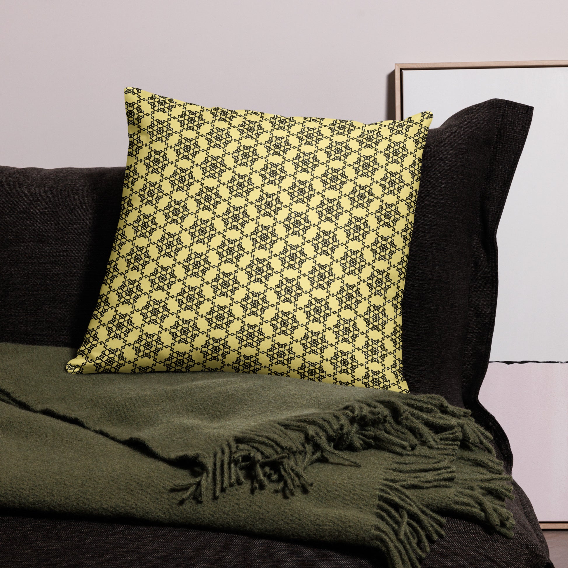 22″×22″ throw pillow with the 'Hexagon' yellow and black geometric pattern on a couch.