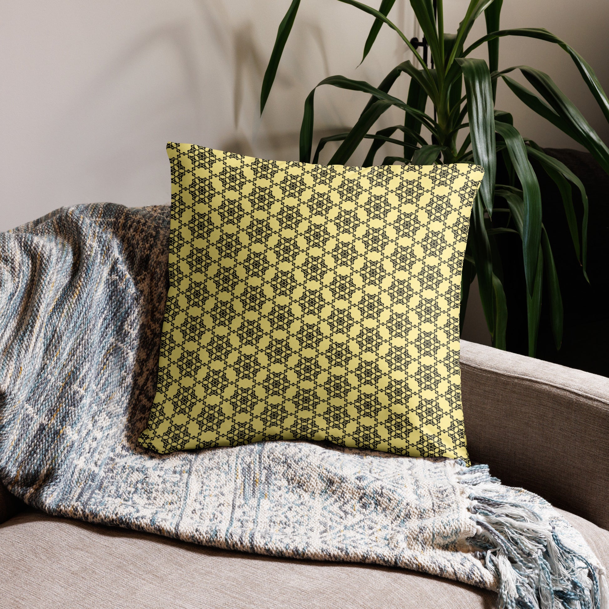 22″×22″ throw pillow with the 'Hexagon' yellow and black geometric pattern on a couch.