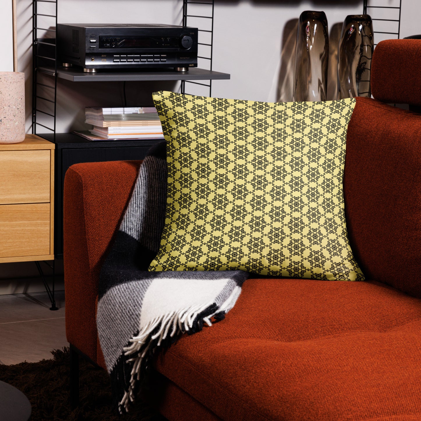 22″×22″ throw pillow with the 'Hexagon' yellow and black geometric pattern on a couch.