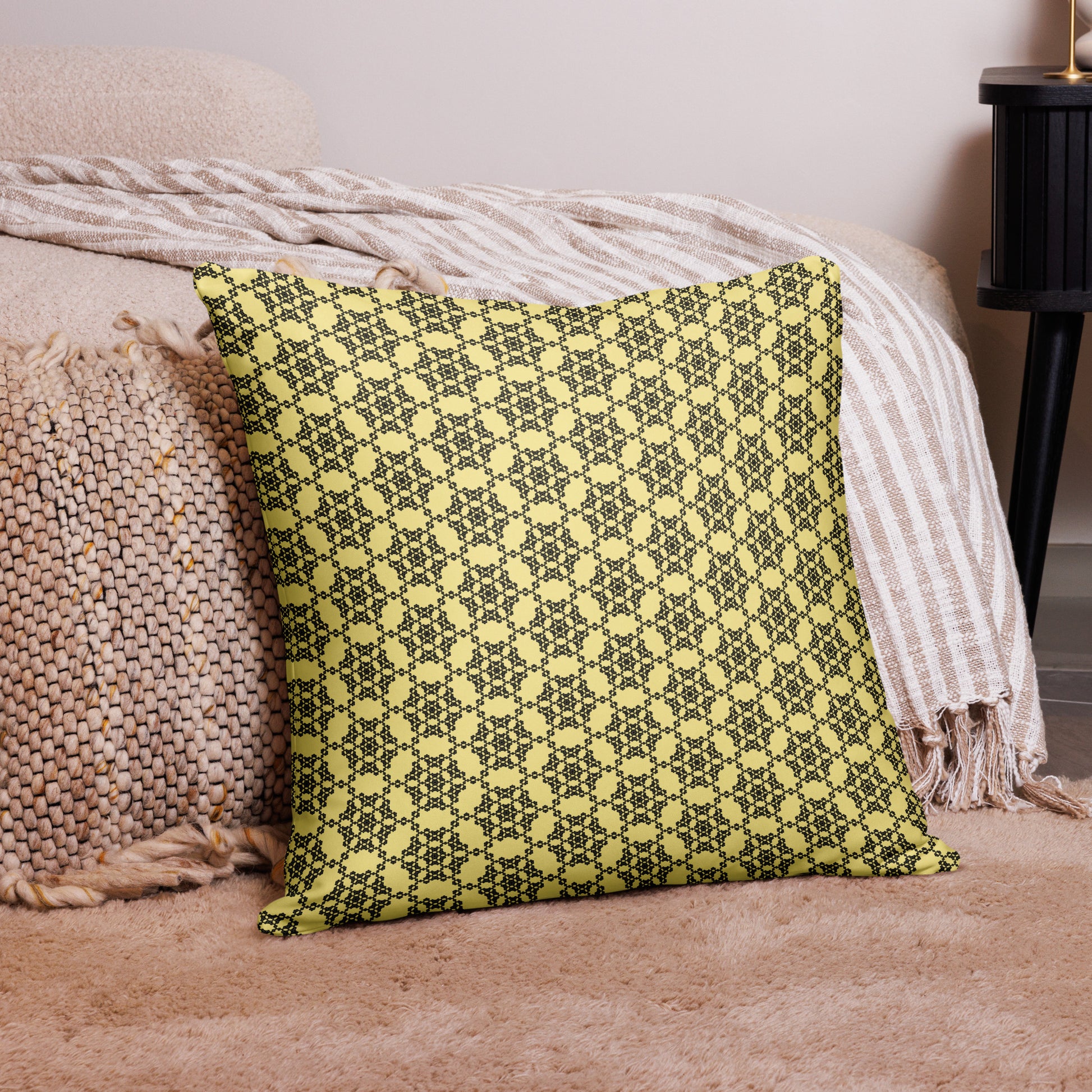 22″×22″ throw pillow with the 'Hexagon' yellow and black geometric pattern on a couch.
