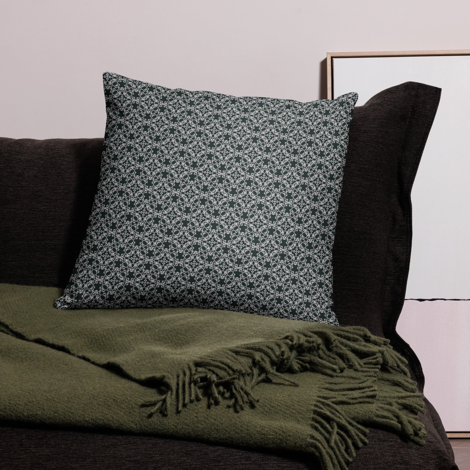 22″×22″ throw pillow with the 'Tetragon' charcoal and white geometric pattern on a couch.