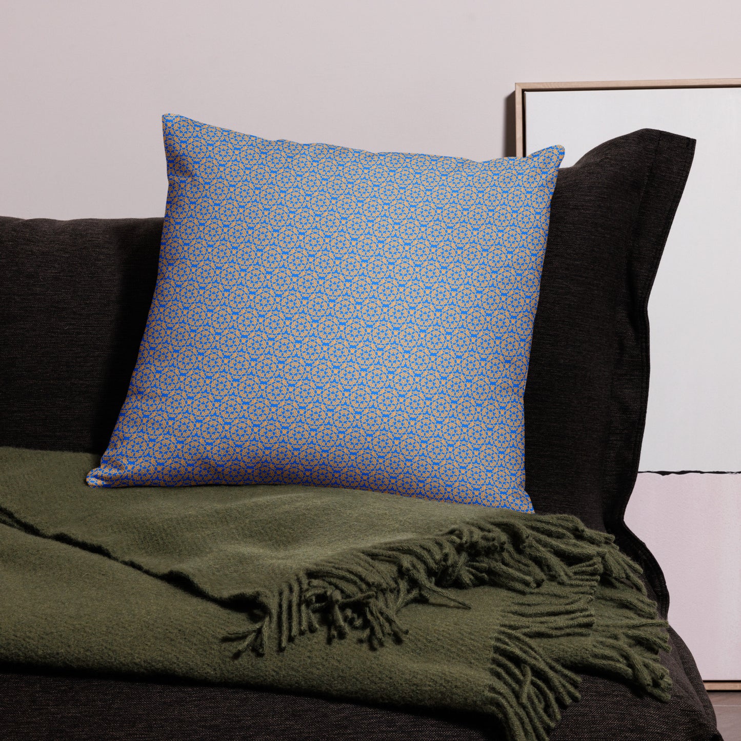 22″×22″ throw pillow with the 'Pentagon' blue and yellow geometric pattern on a couch.