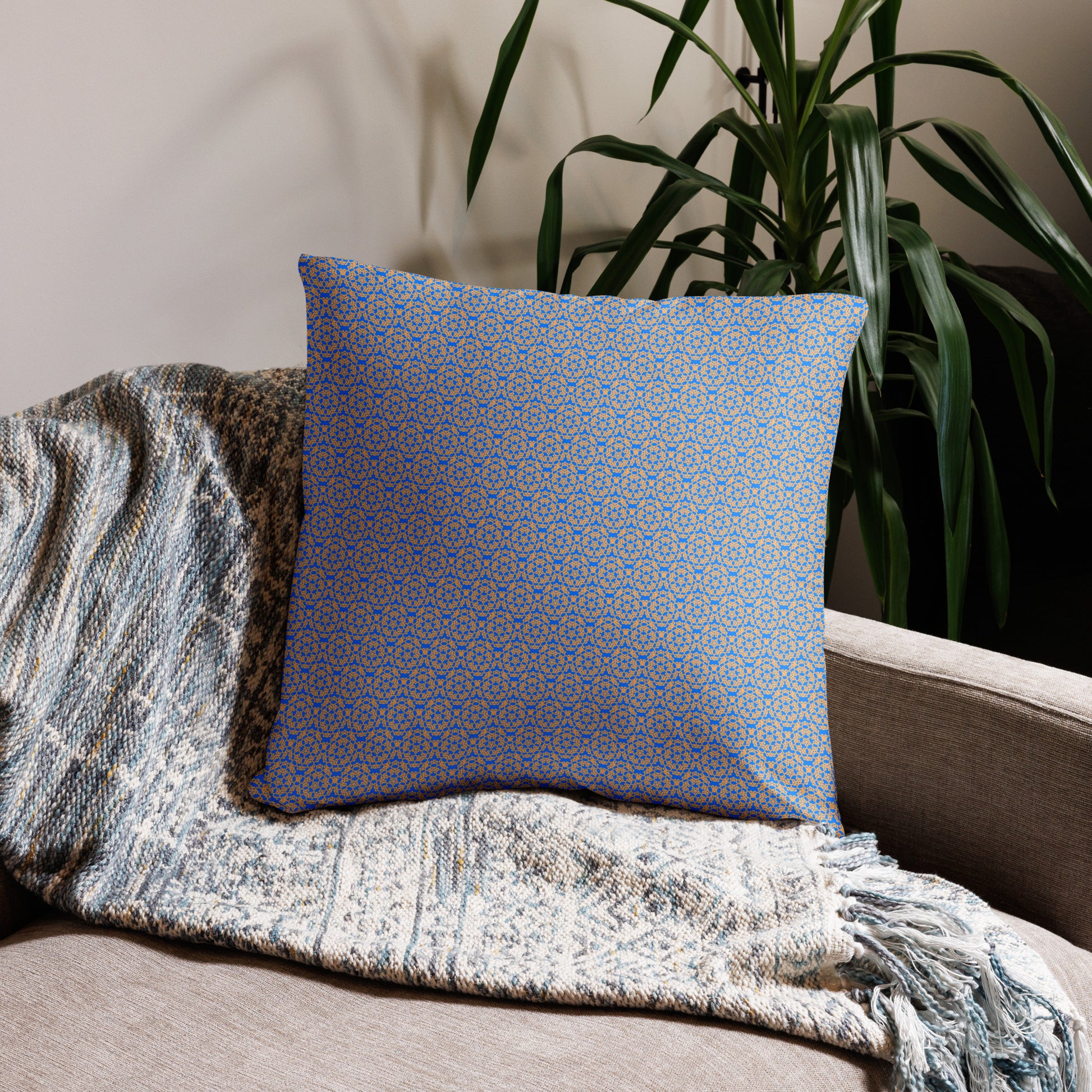 22″×22″ throw pillow with the 'Pentagon' blue and yellow geometric pattern on a couch.