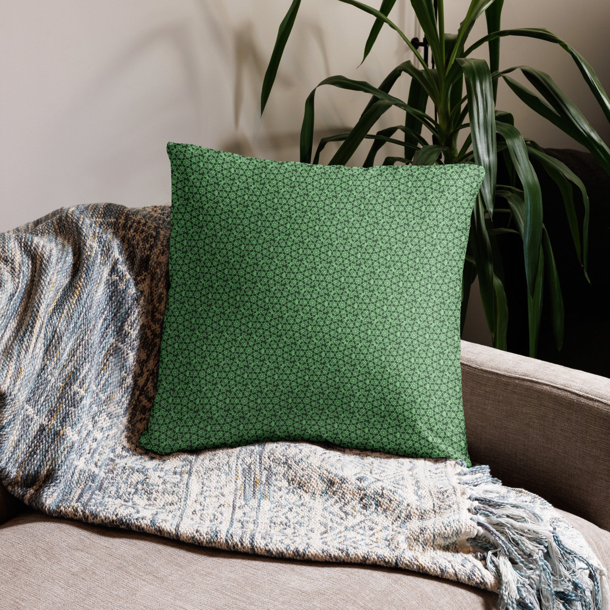 22″×22″ throw pillow with the 'Heptagon' green geometric pattern on a couch.