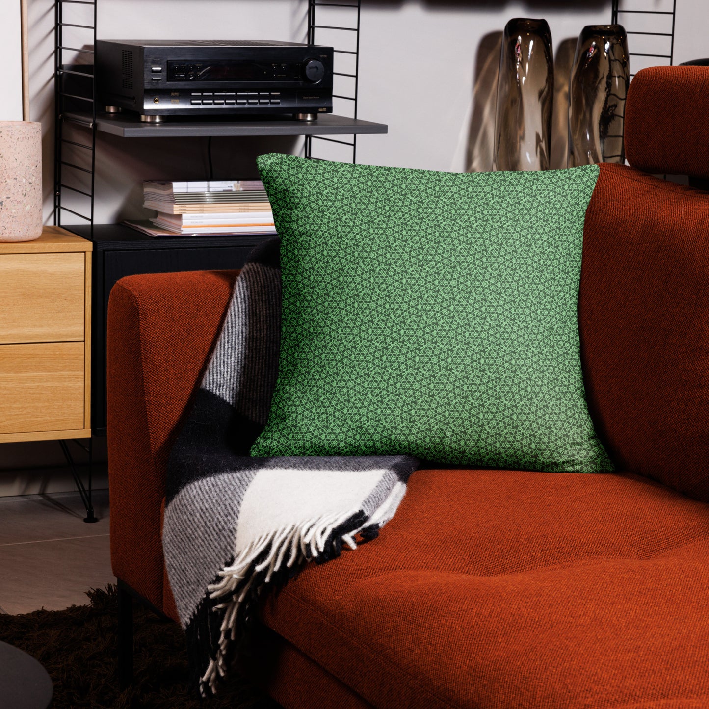 22″×22″ throw pillow with the 'Heptagon' green geometric pattern on a couch.