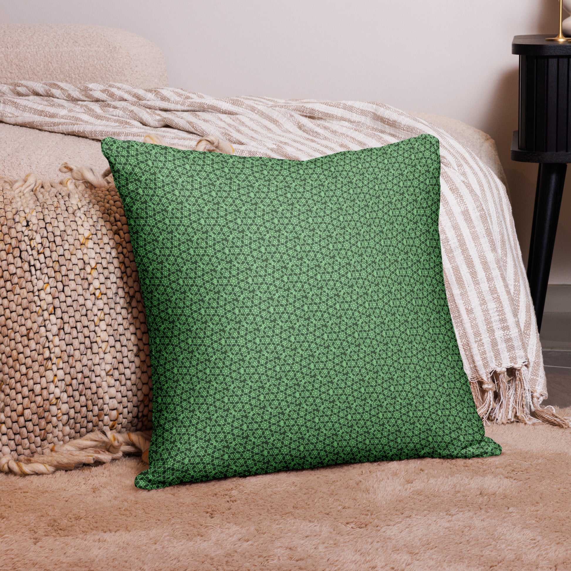 22″×22″ throw pillow with the 'Heptagon' green geometric pattern on a couch.