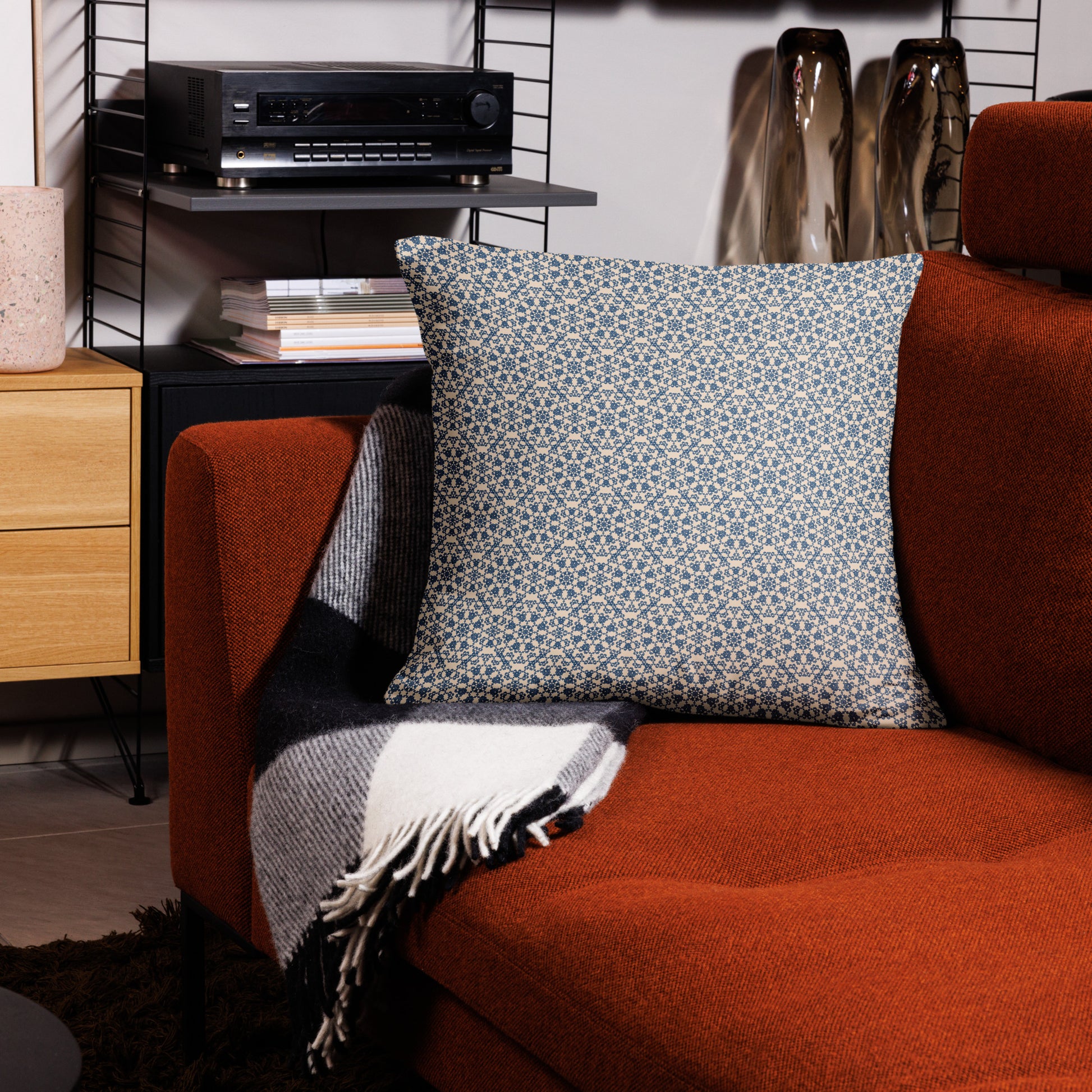 22″×22″ throw pillow with the ‘Octagon’ navy and beige geometric pattern on an armchair.