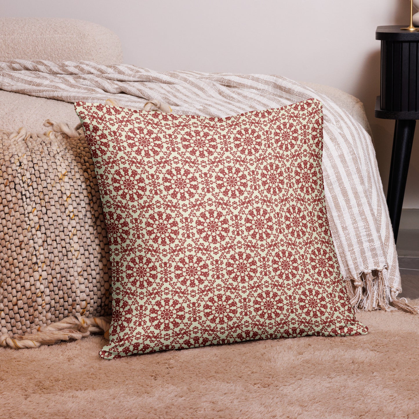 22″×22″ throw pillow with the ‘Decagon’ terracotta and beige geometric pattern on a bedroom floor with striped linen throws.