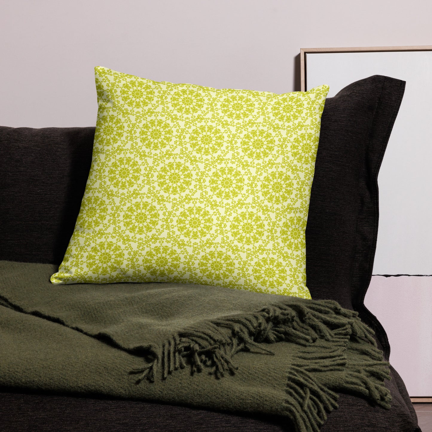 22″×22″ throw pillow with the 'Hendecagon' yellow-green geometric pattern on a dark sofa with green throw