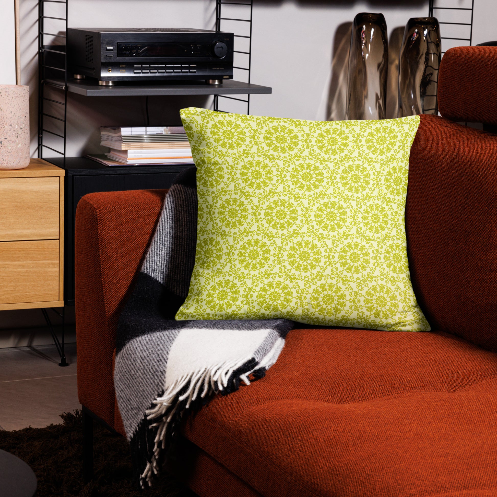 22″×22″ throw pillow with the 'Hendecagon' yellow-green geometric pattern on a terracotta sofa in a modern living room