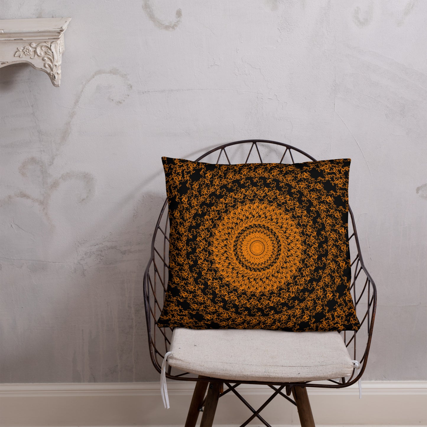 22″×22″ throw pillow with the 'The Sun' orange and black geometric design on a chair.