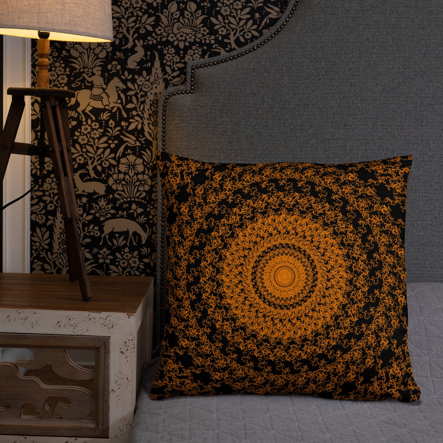 22″×22″ throw pillow with the 'The Sun' orange and black geometric design on a bed.