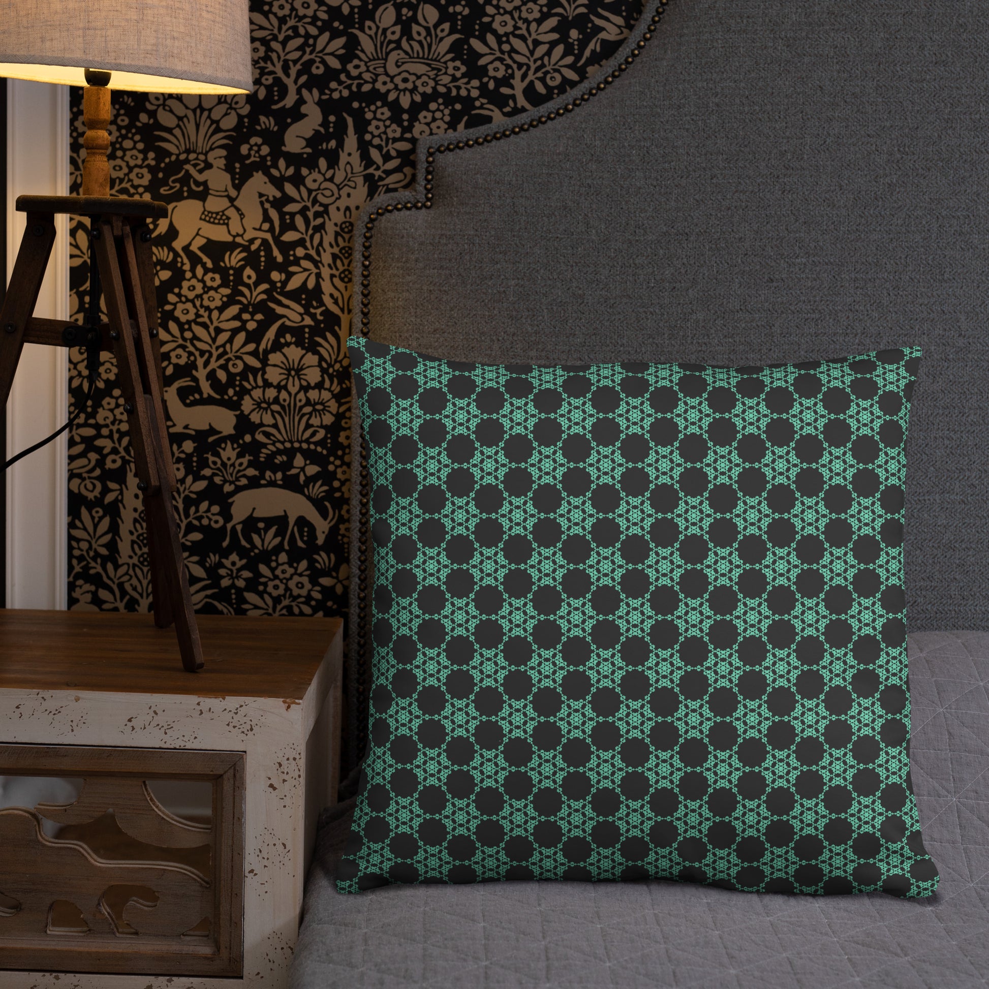 22″×22″ throw pillow with the 'Flowers Victory' charcoal and mint geometric pattern on a bed.