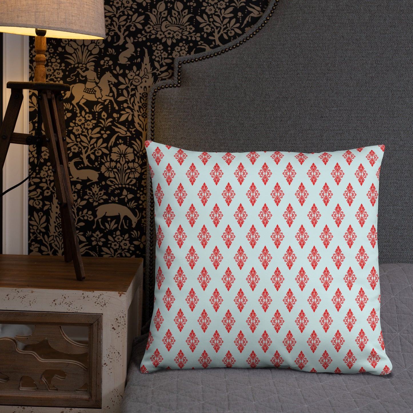 22″×22″ throw pillow with the 'Digon' sky blue and red geometric pattern on a bed.