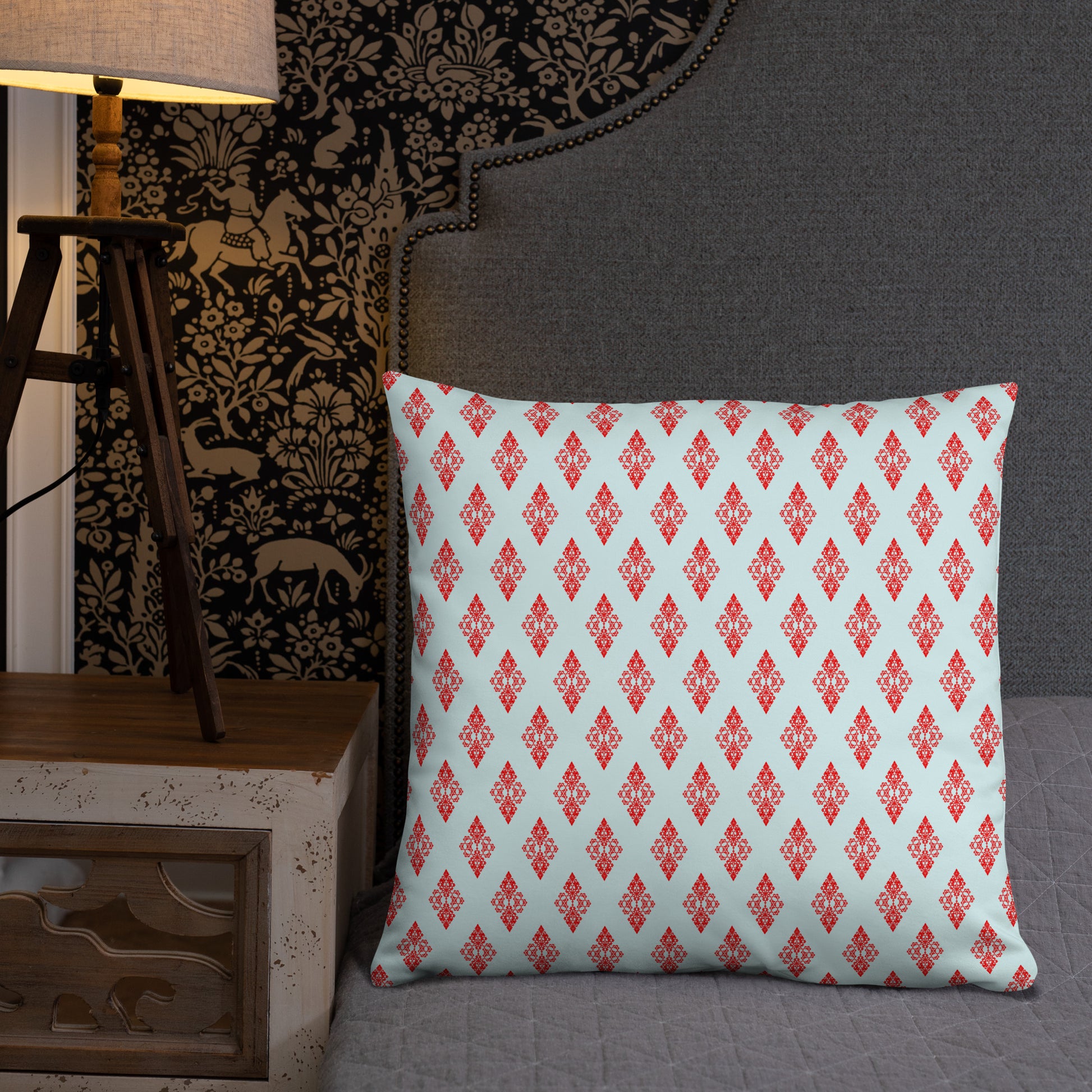 22″×22″ throw pillow with the 'Digon' sky blue and red geometric pattern on a bed.