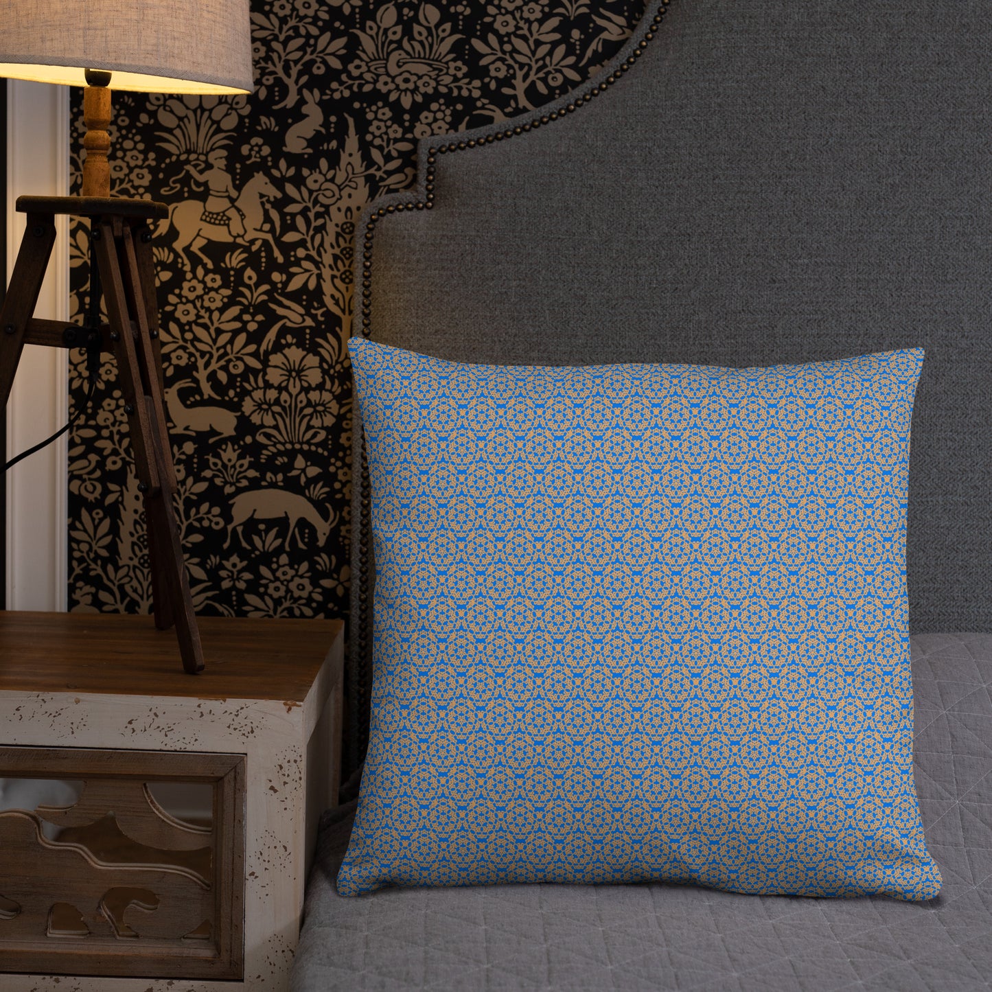 22″×22″ throw pillow with the 'Pentagon' blue and yellow geometric pattern on a bed.