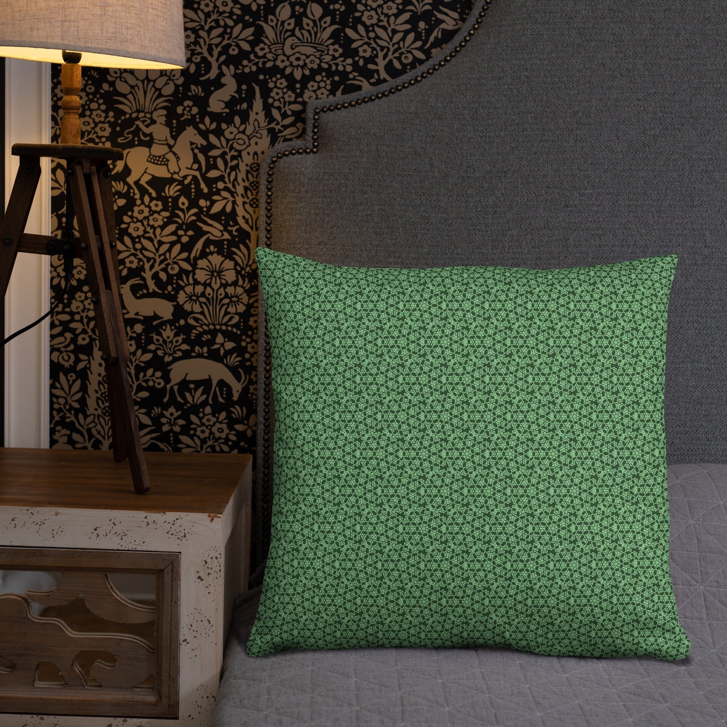 22″×22″ throw pillow with the 'Heptagon' green geometric pattern on a bed.