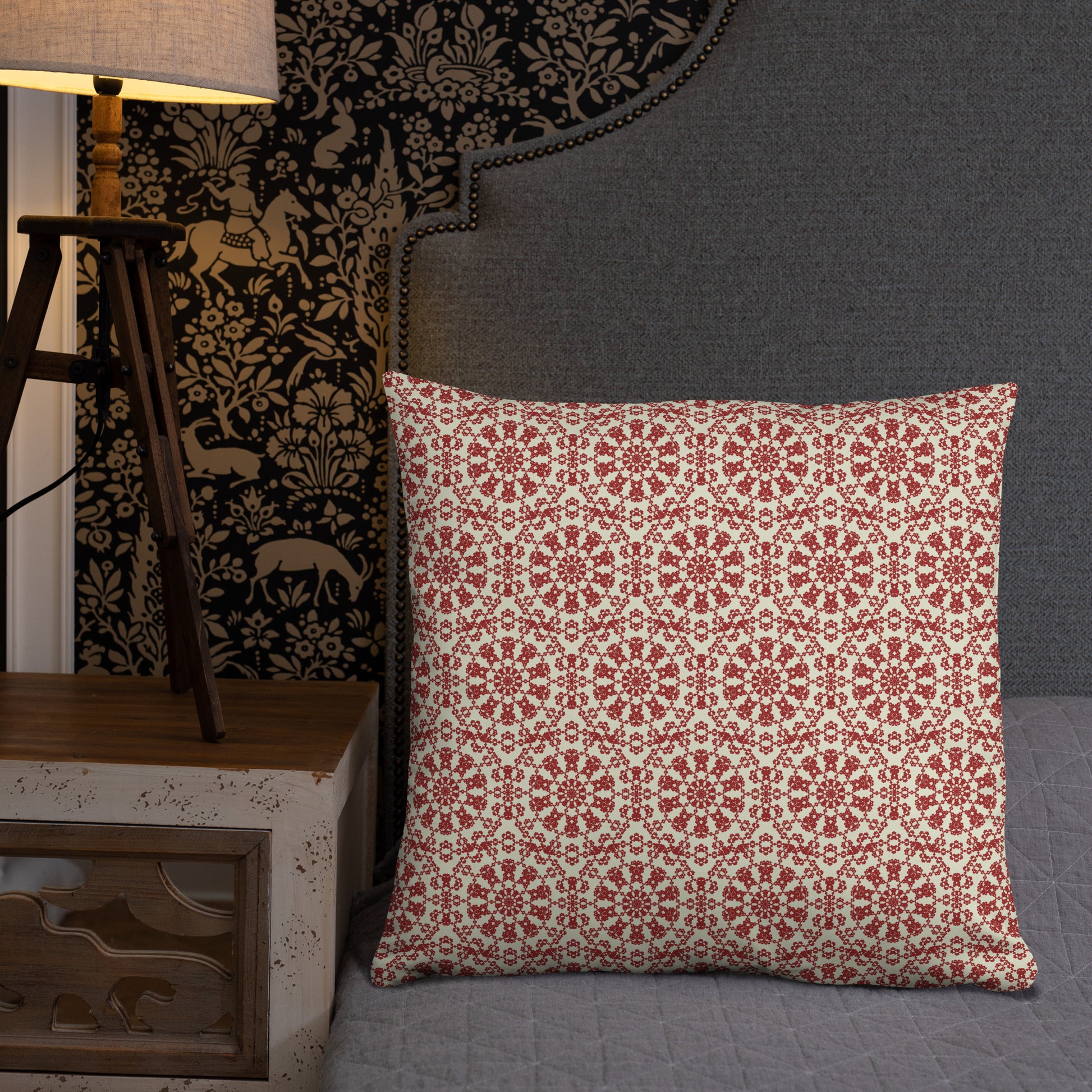 22″×22″ throw pillow with the ‘Decagon’ terracotta and beige geometric pattern on a grey bed with an ornate headboard.