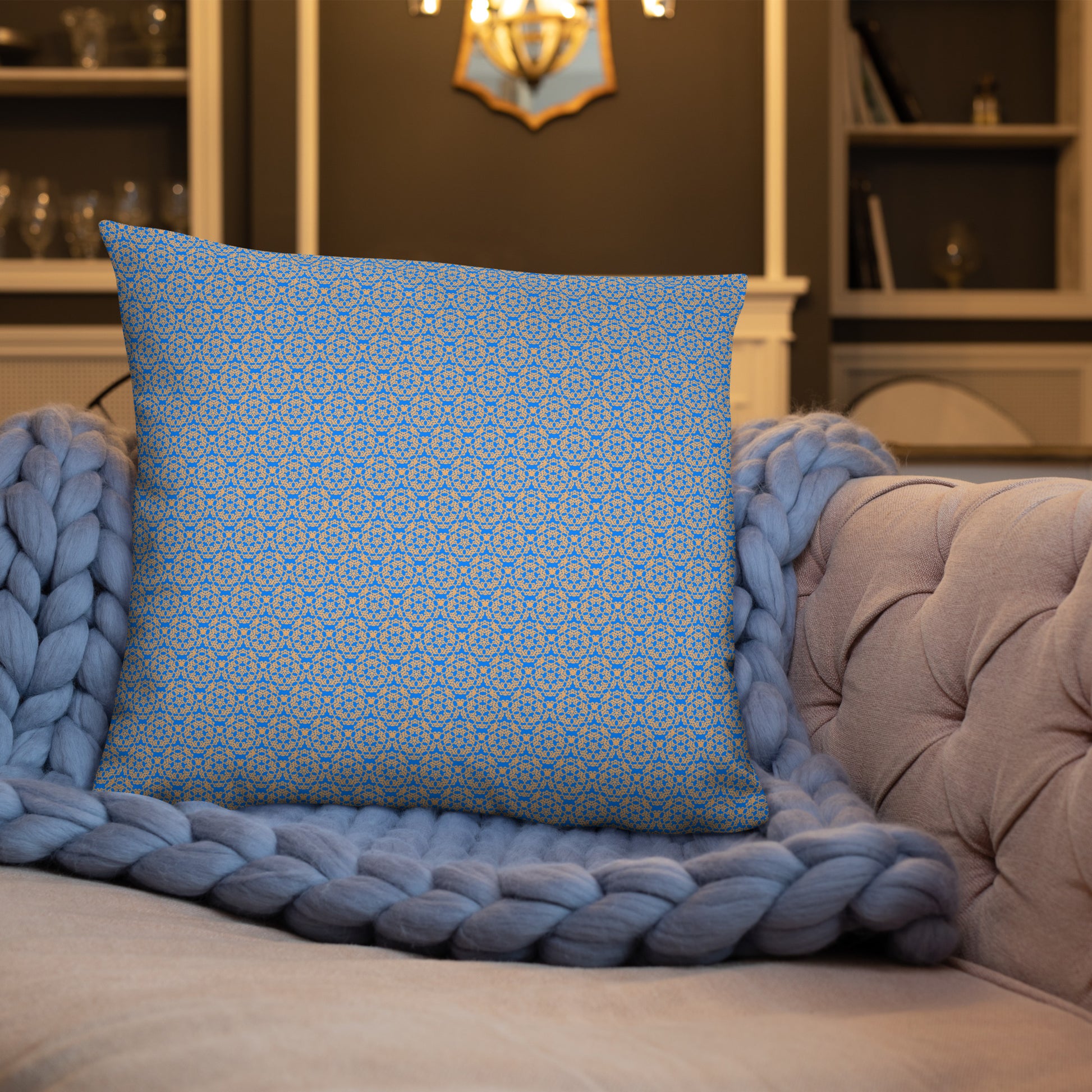 Front of the 22″×22″ basic pillow with the 'Pentagon' blue and yellow fractal geometric pattern on a sofa.