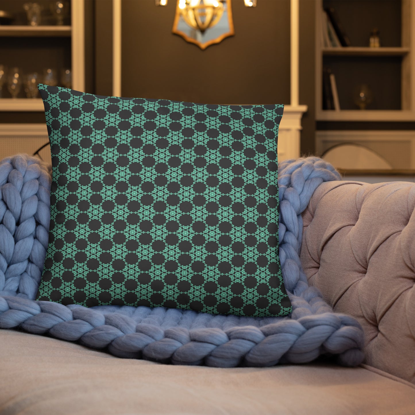 22″×22″ throw pillow with the 'Flowers Victory' charcoal and mint geometric pattern on a sofa.