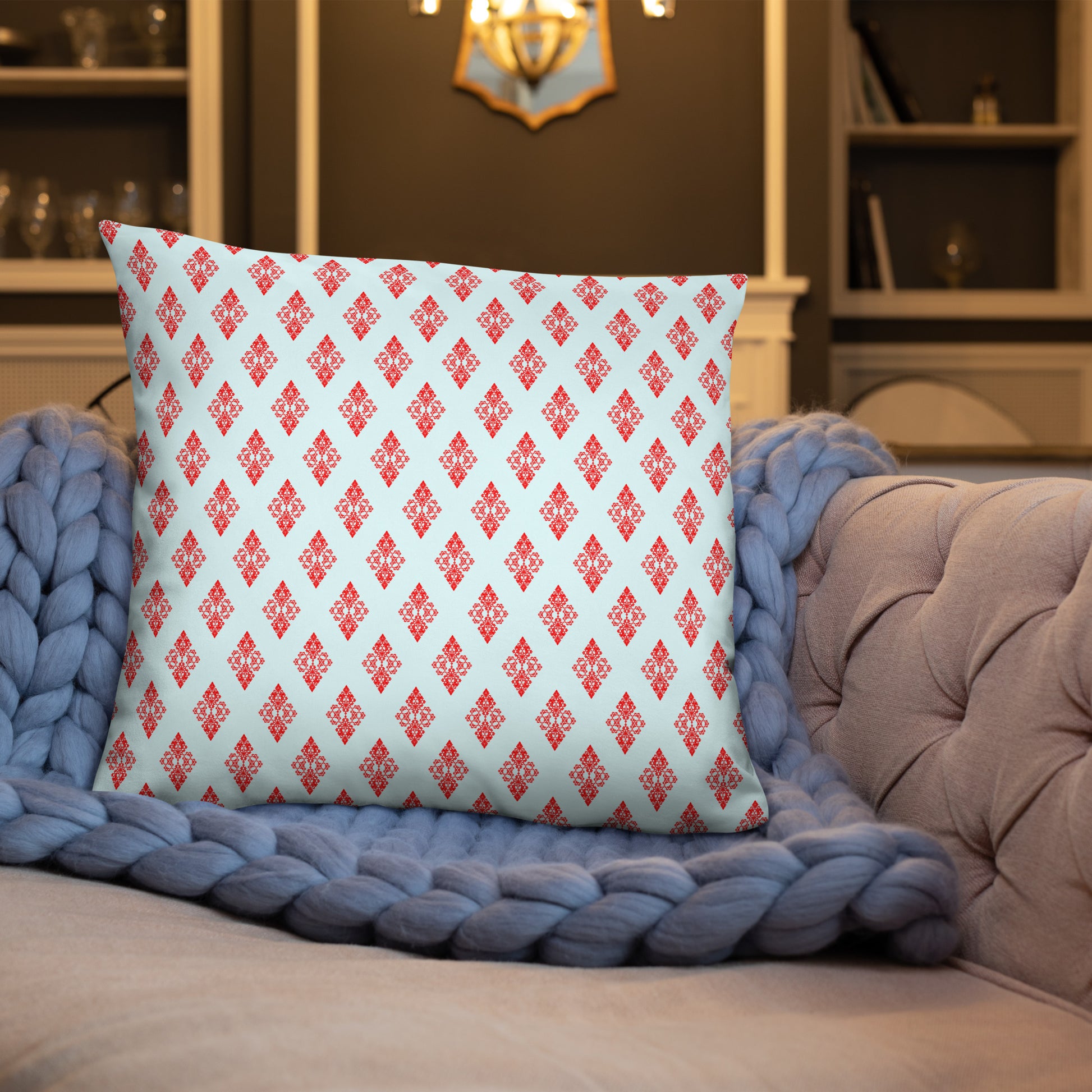 22″×22″ throw pillow with the 'Digon' sky blue and red geometric pattern on a sofa.