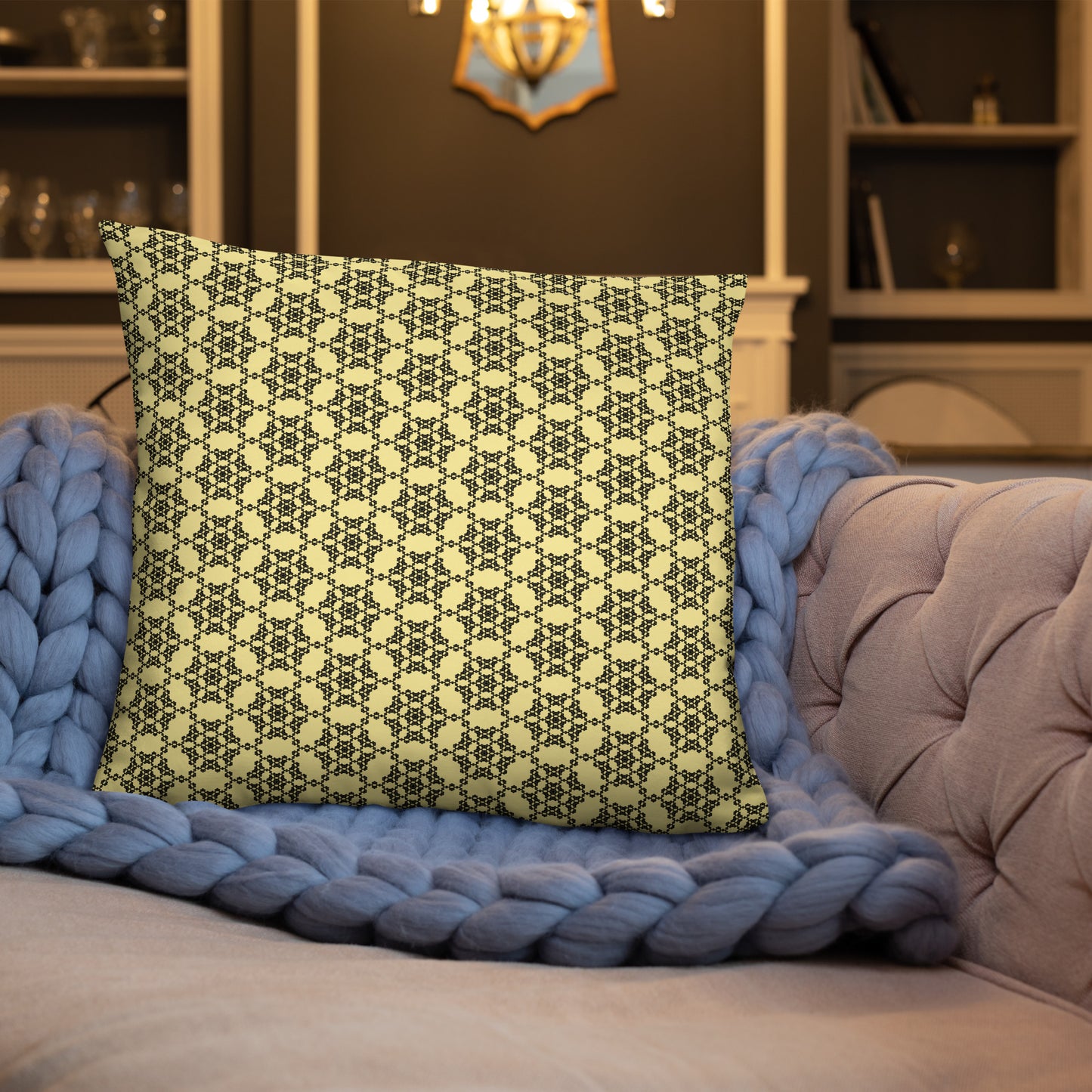 22″×22″ throw pillow with the 'Hexagon' yellow and black geometric pattern on a sofa.