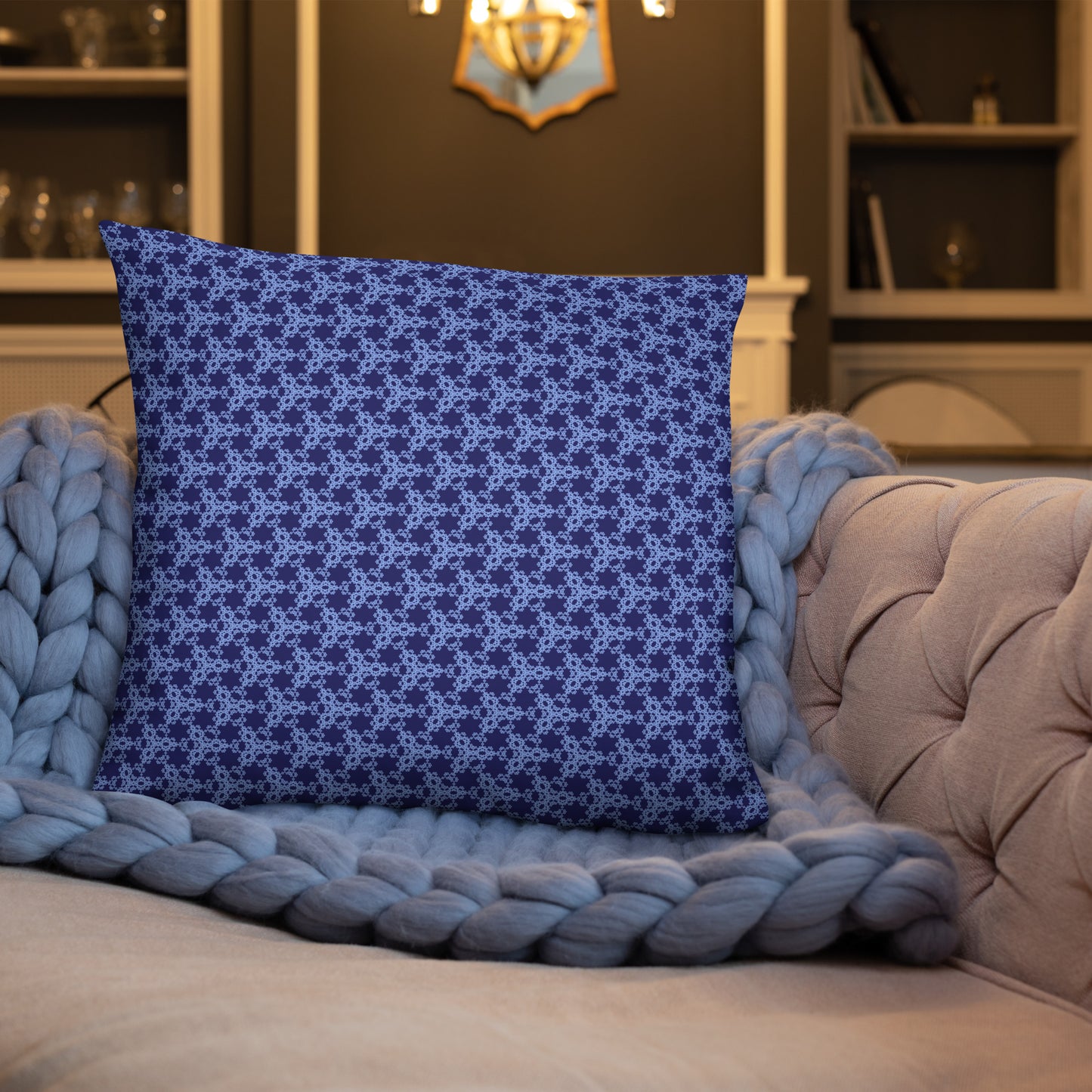 22″×22″ throw pillow with the 'Triagon' navy and blue geometric pattern on a sofa.