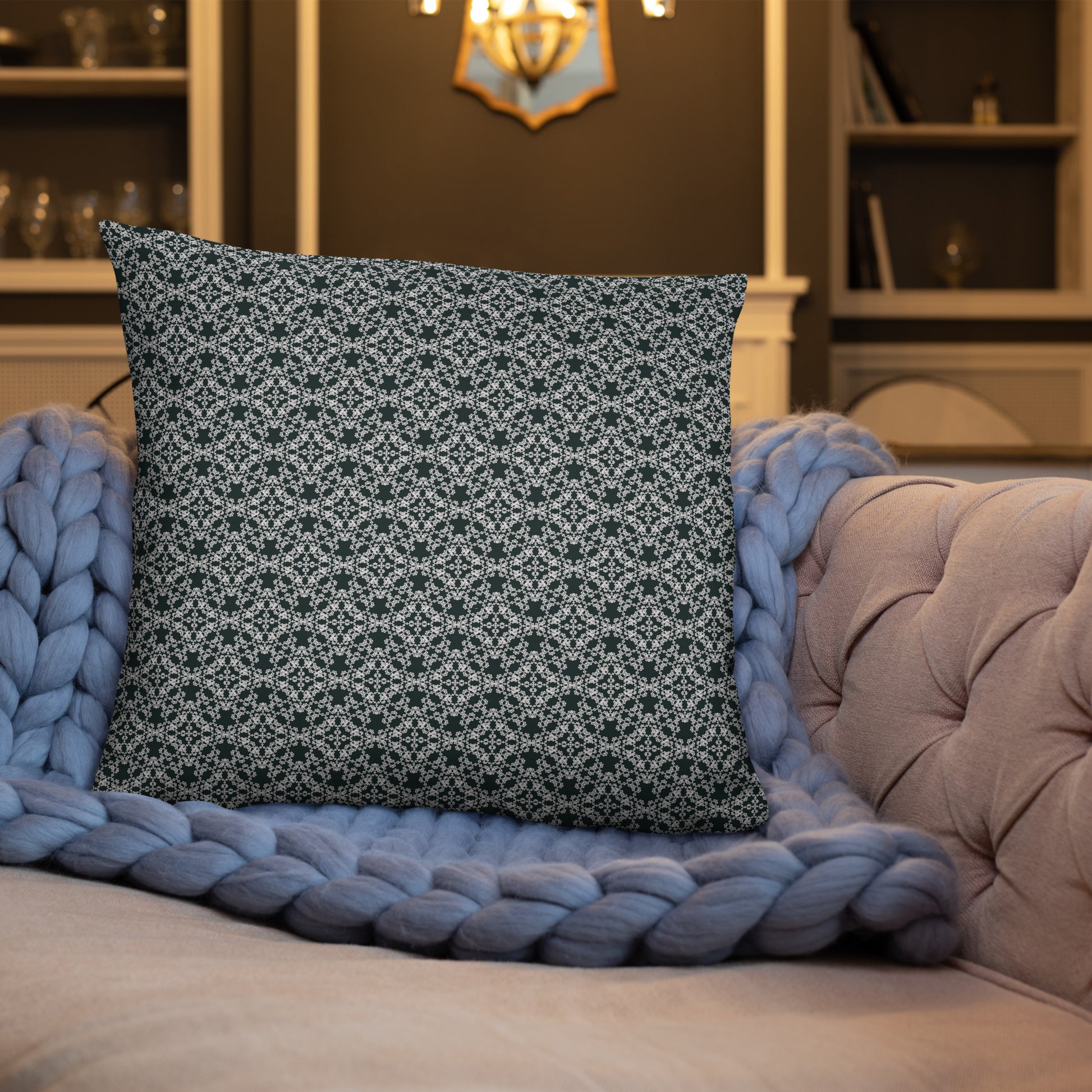 22″×22″ throw pillow with the 'Tetragon' charcoal and white geometric pattern on a sofa.
