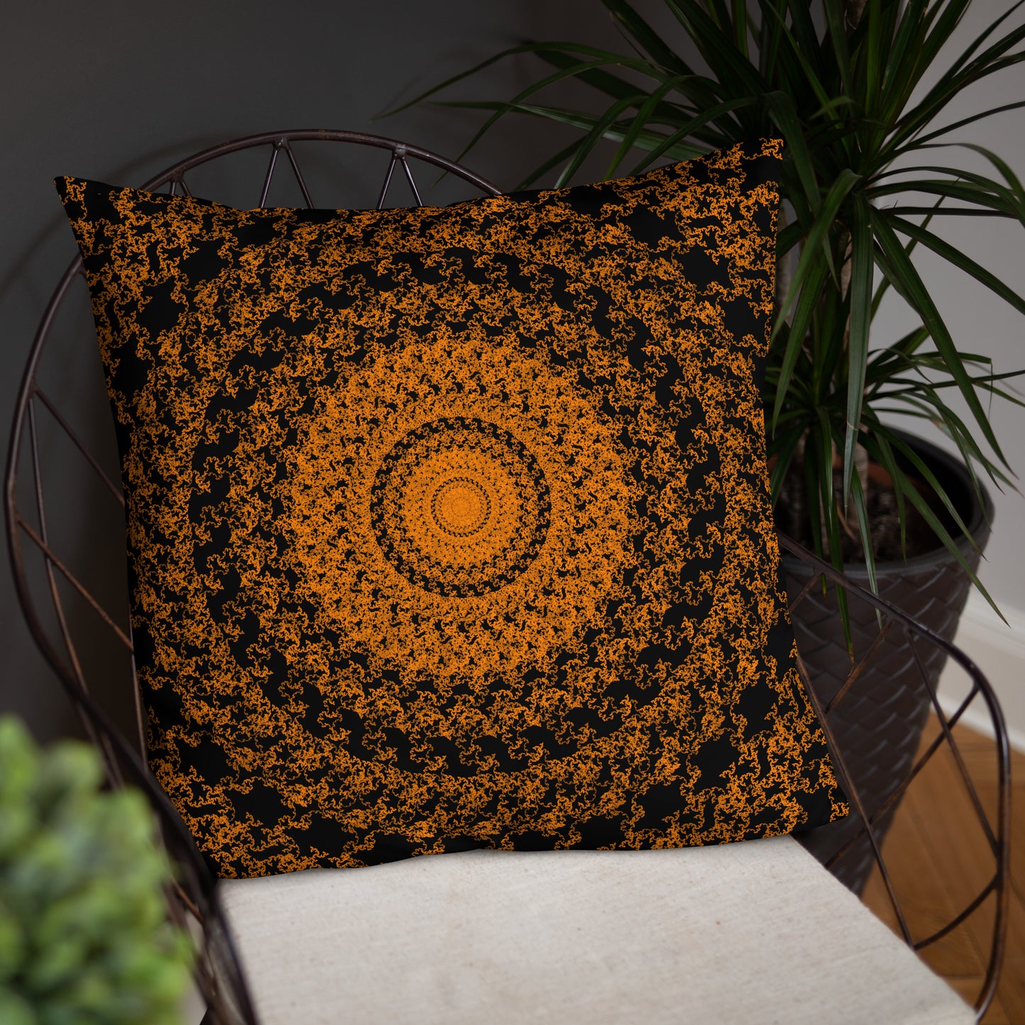 22″×22″ throw pillow with the 'The Sun' orange and black geometric design on a chair.
