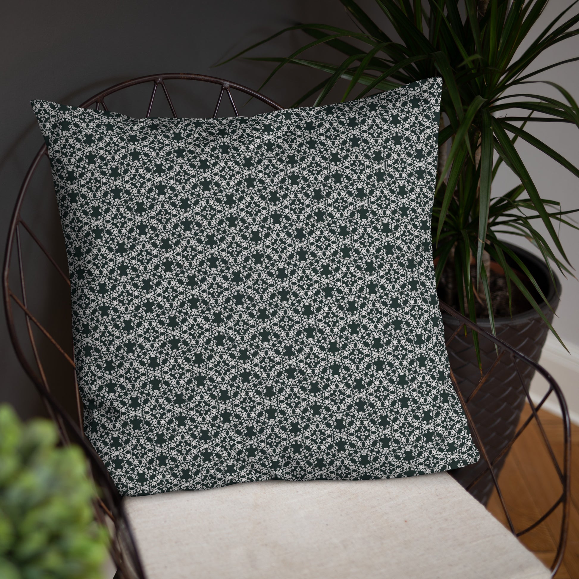 22″×22″ throw pillow with the 'Tetragon' charcoal and white geometric pattern on a chair.
