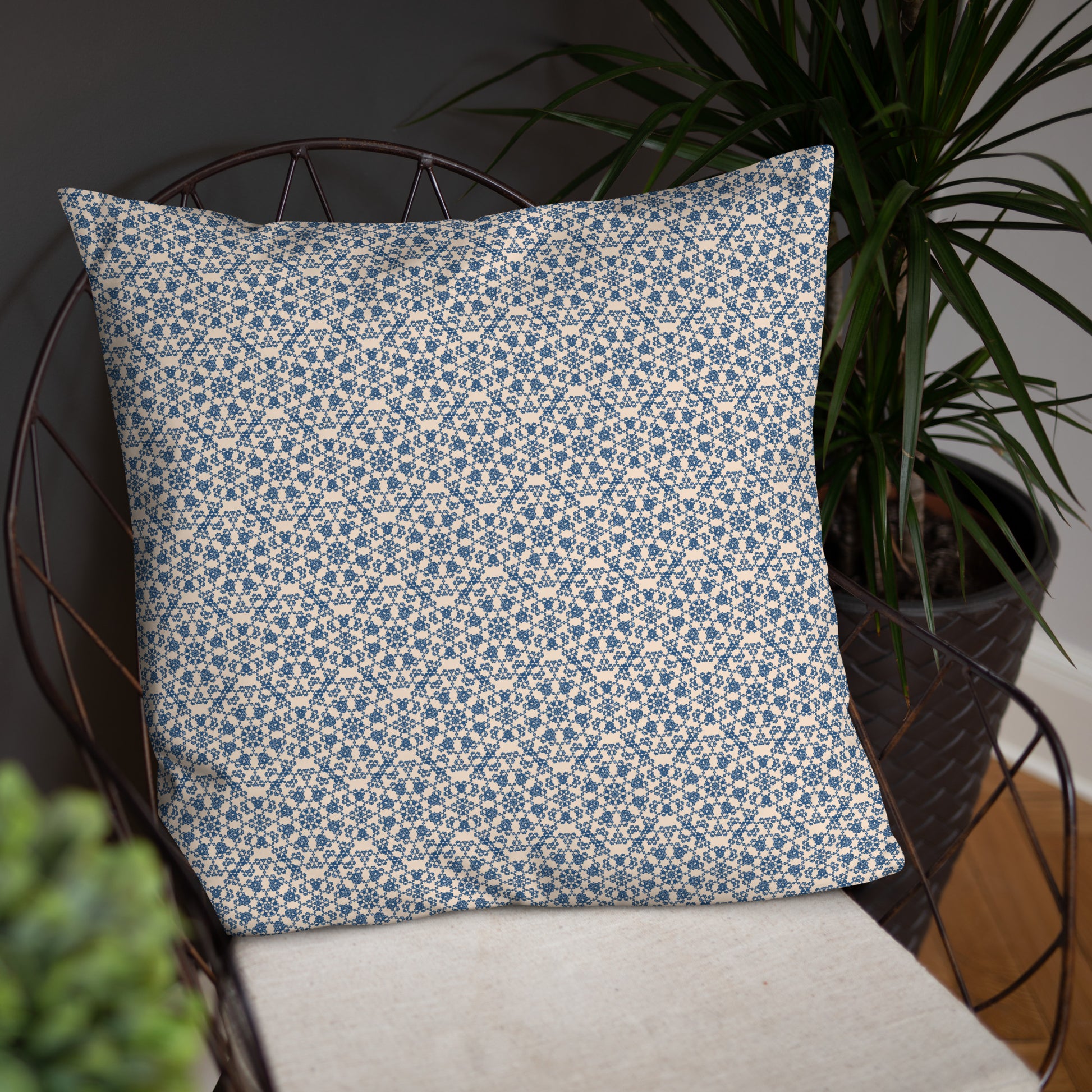 22″×22″ throw pillow with the ‘Octagon’ navy and beige geometric pattern on a wire chair.