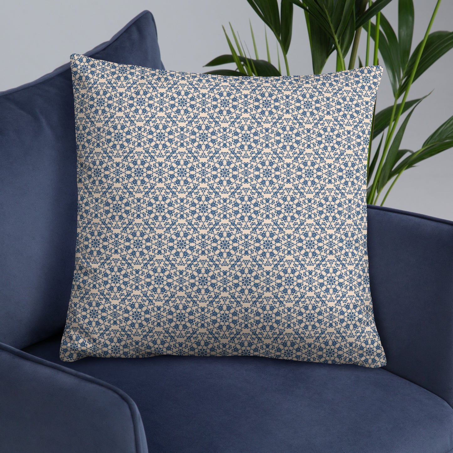 22″×22″ throw pillow with the ‘Octagon’ navy and beige geometric pattern on a navy sofa.